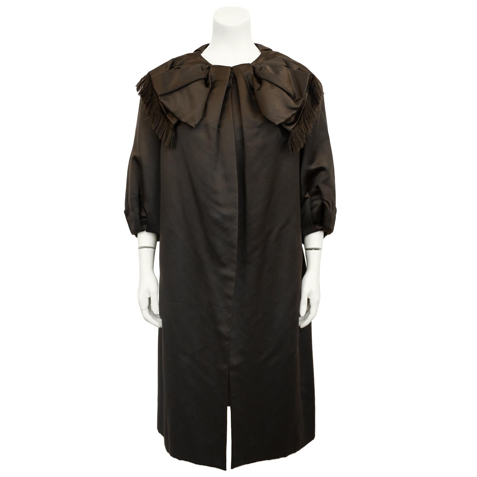 Stunning chocolate brown Dior inspired opera coat from the 1950's, from Holt Renfrew in Toronto. Oversized bow detail at neck with fringe. Opera length sleeves to wear with gloves. Single snap closure at neck. Inverted pleats at back side seams give