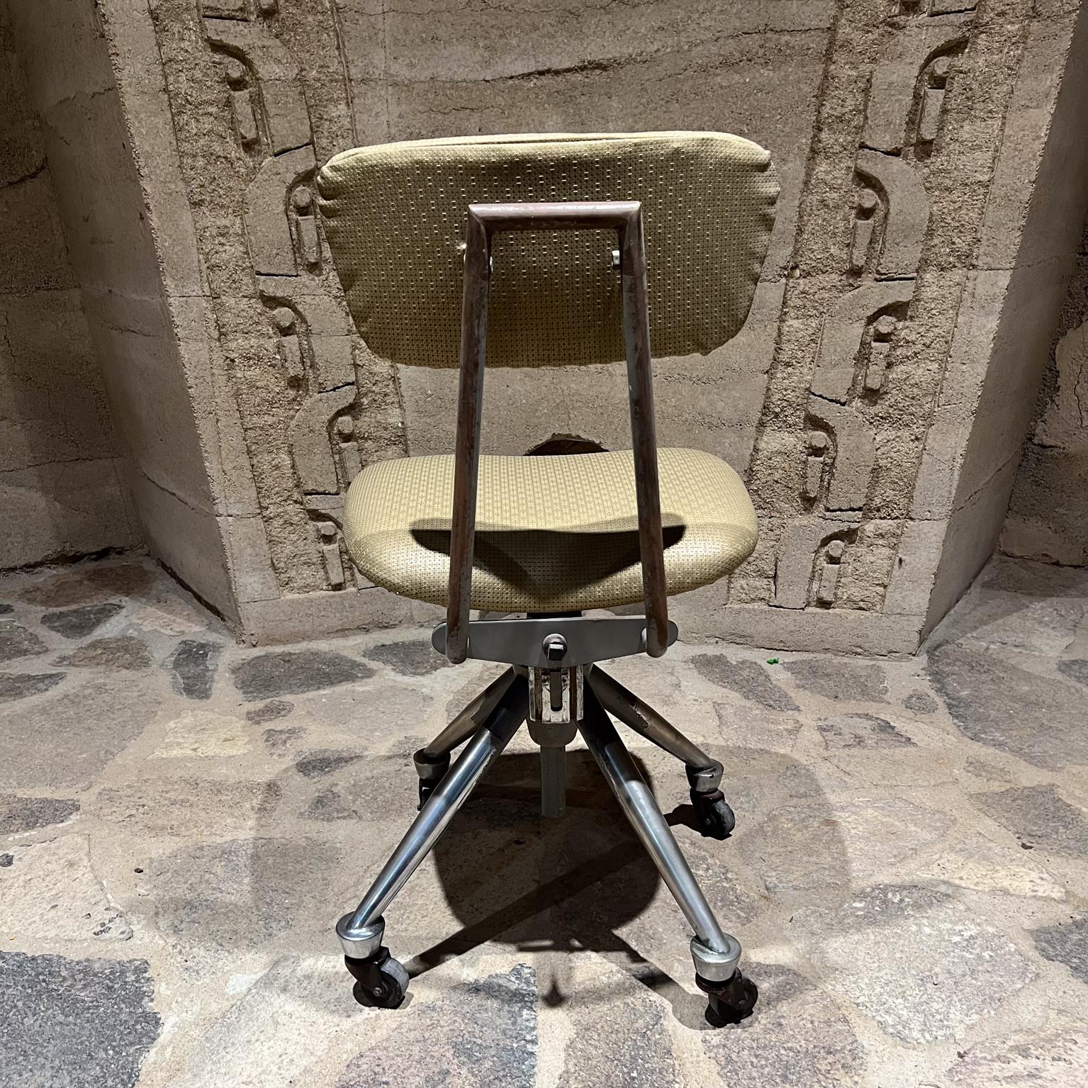 1950s Do More Office Chair Mid-Century Modern industrial era.
Domore Chair Company Inc founded in 1922 
by William S. Ferris in Elkhart, Indiana.
Seat height adjustable.
Four-star base original chrome and rubber wheels.
Unusual base with a