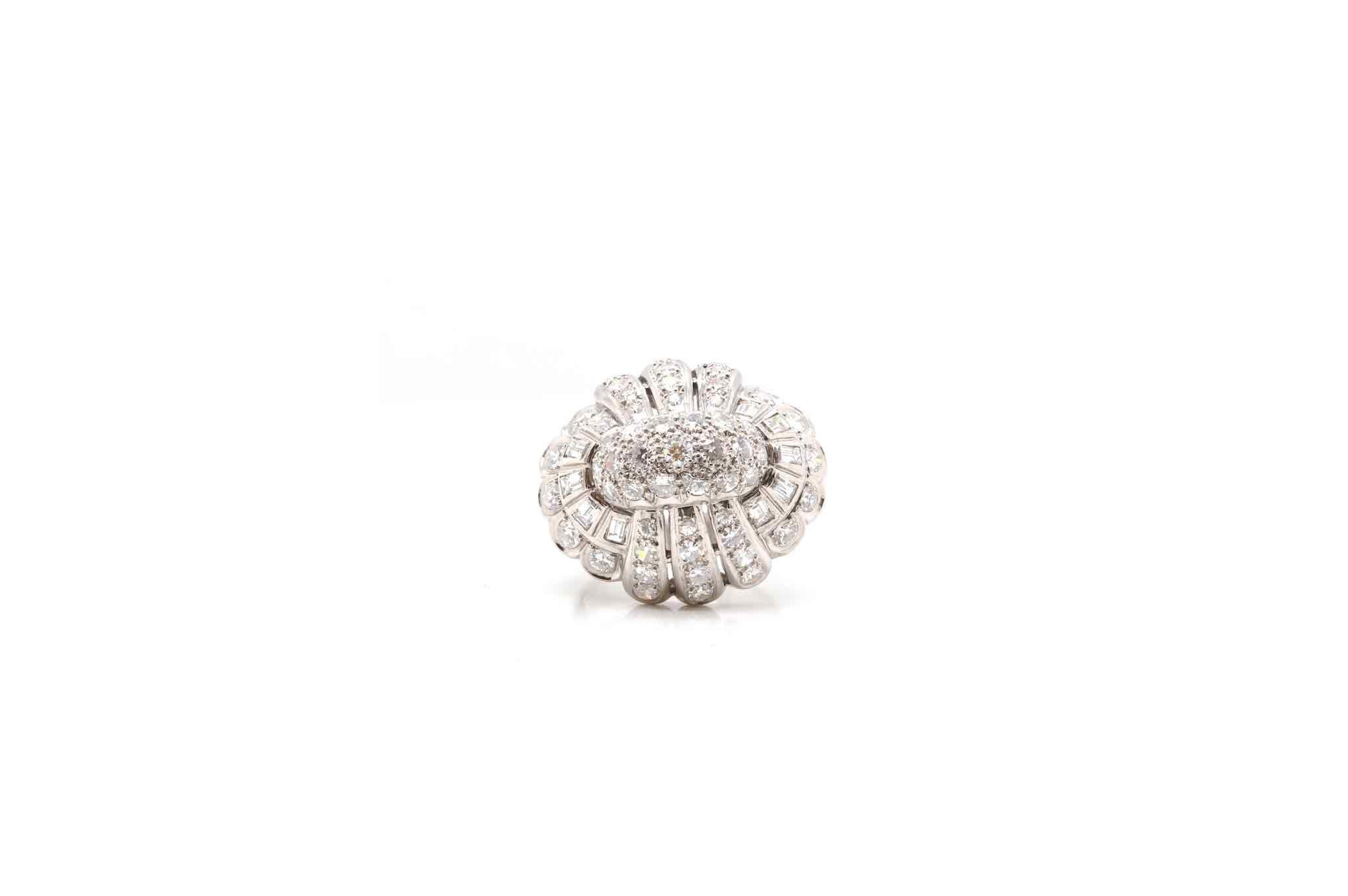 Stones: Brilliant cut diamonds
and baguettes for a total weight of 1.80 carats.
Material: Platinum
Dimensions: 23 mm length on finger, 15 mm height
Weight: 14.9g
Size: 55 (free sizing)
Certificate
Ref. : 24721