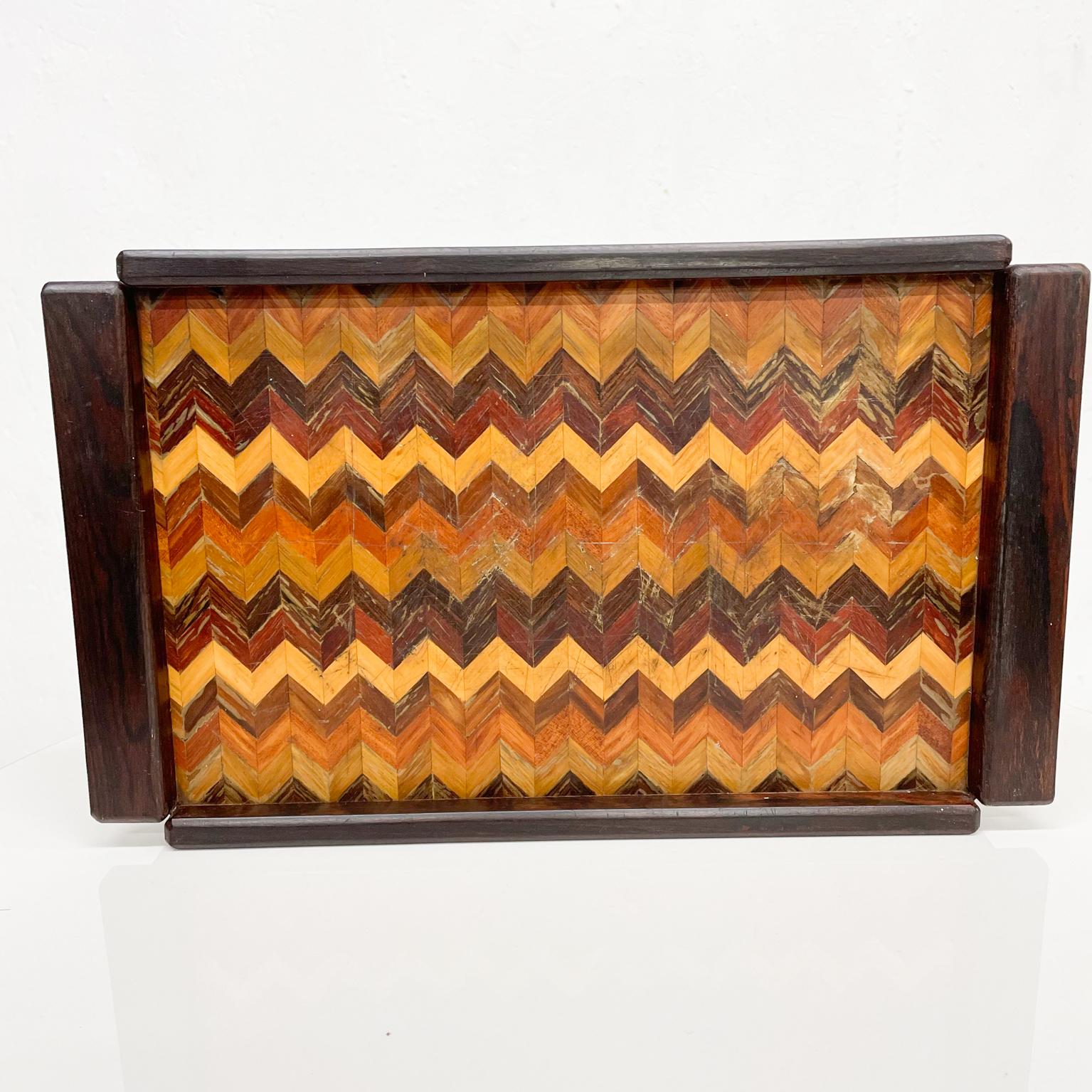 Service Tray
Don Shoemaker for senal service tray in cocobolo exotic tropical wood medley Morelia Mexico 1950s
Medium size tray. Geometric Design.
Maker label present.
Measures: 15 L x 9 W x 1.18 (3/16) inches
Original preowned vintage