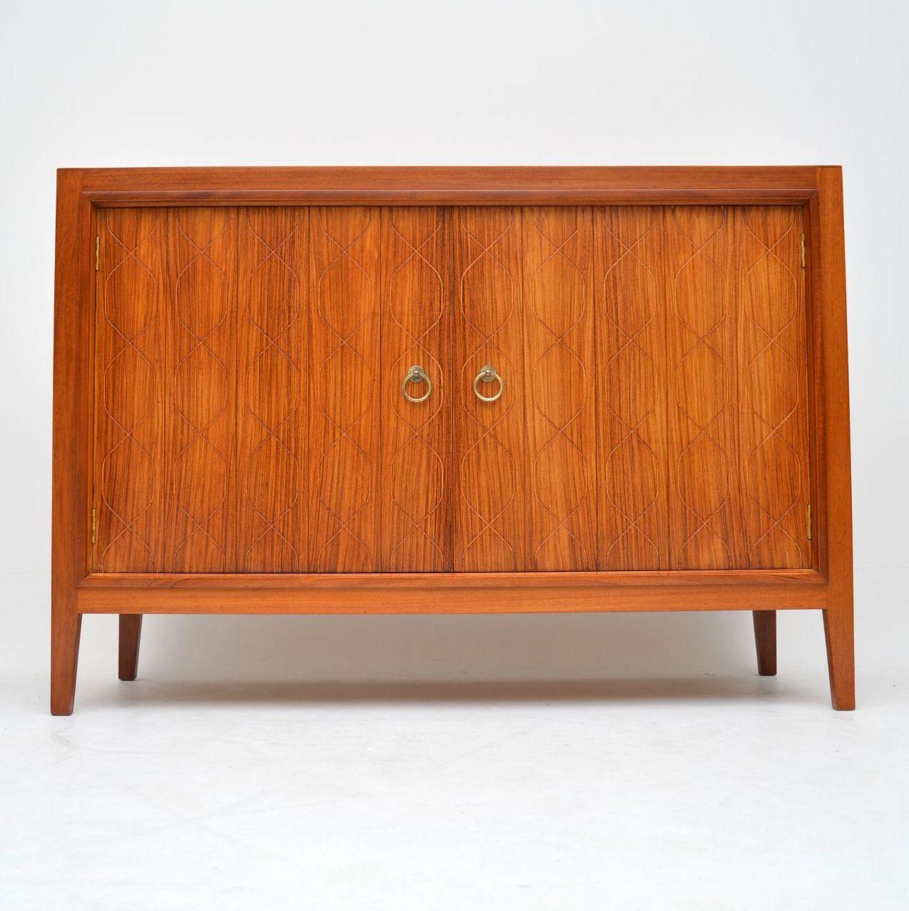 A stunning and iconic vintage sideboard designed by David Booth and Judith Ledeboer, manufactured by Gordon Russell. This was designed in the very early 1950s, and was on display at the festival of Britain in 1951. It went into production from 1953,