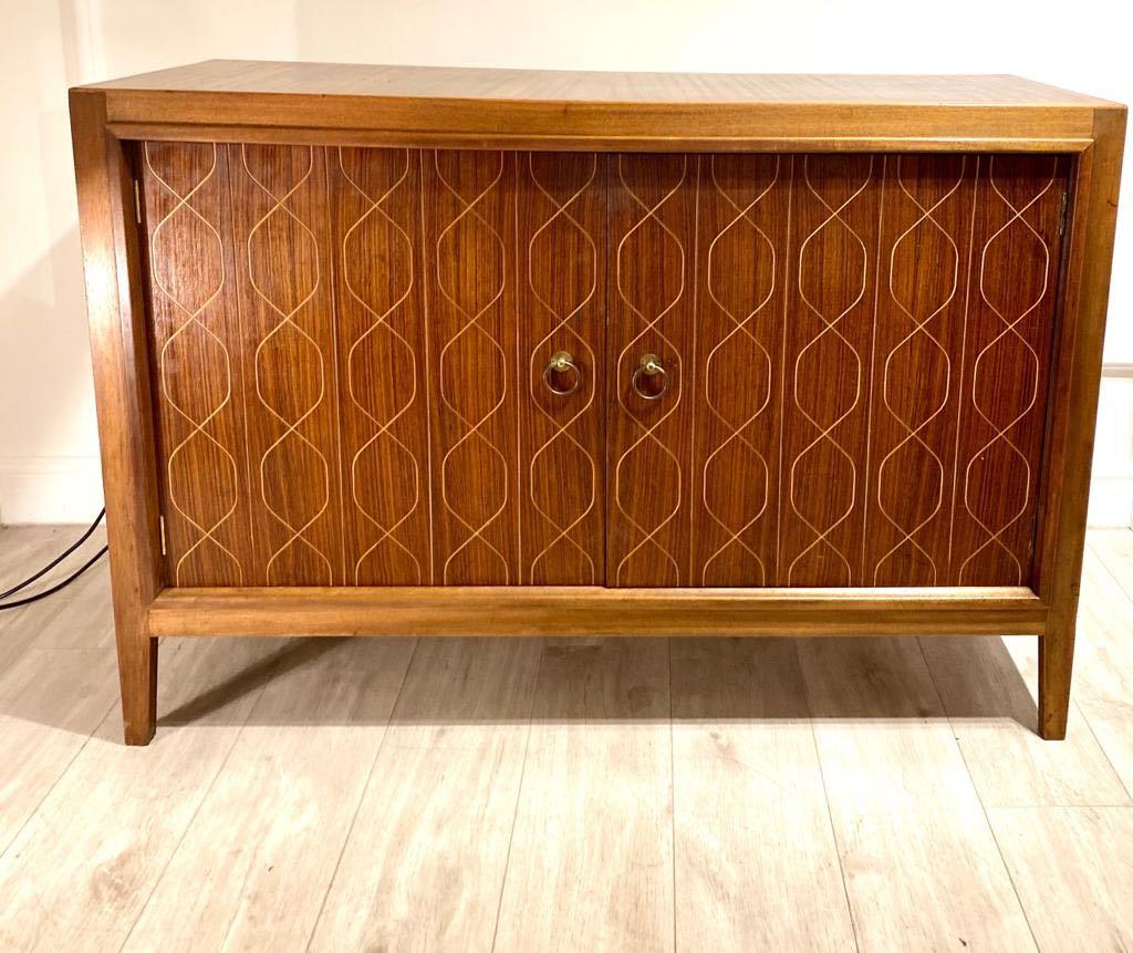 A Mahogany and rosewood sideboard designed by David Booth and Judith Ledeboer for Gordon Russell of Broadway. Model 407 originally exhibited at the Festival of Britain in 1951, later went into production in 1953, it has since become an iconic piece