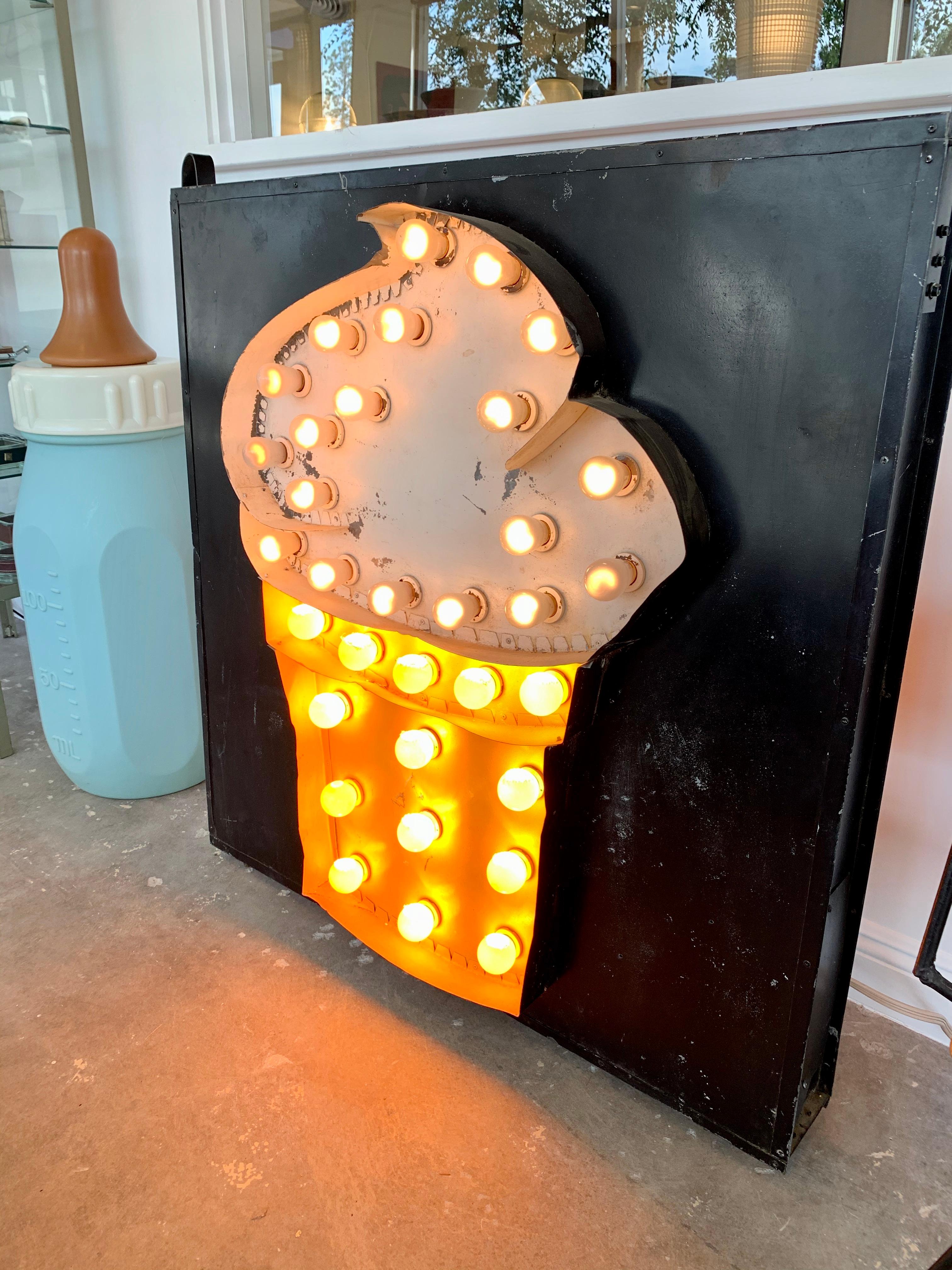 1950s double-sided metal sign with an ice cream cone. Made of sheet metal. Each side has a hand painted ice cream cone with sheet metal outlining the shape. A total of 34 light bulbs illuminate each side. Very cool piece of pop art. Great vintage