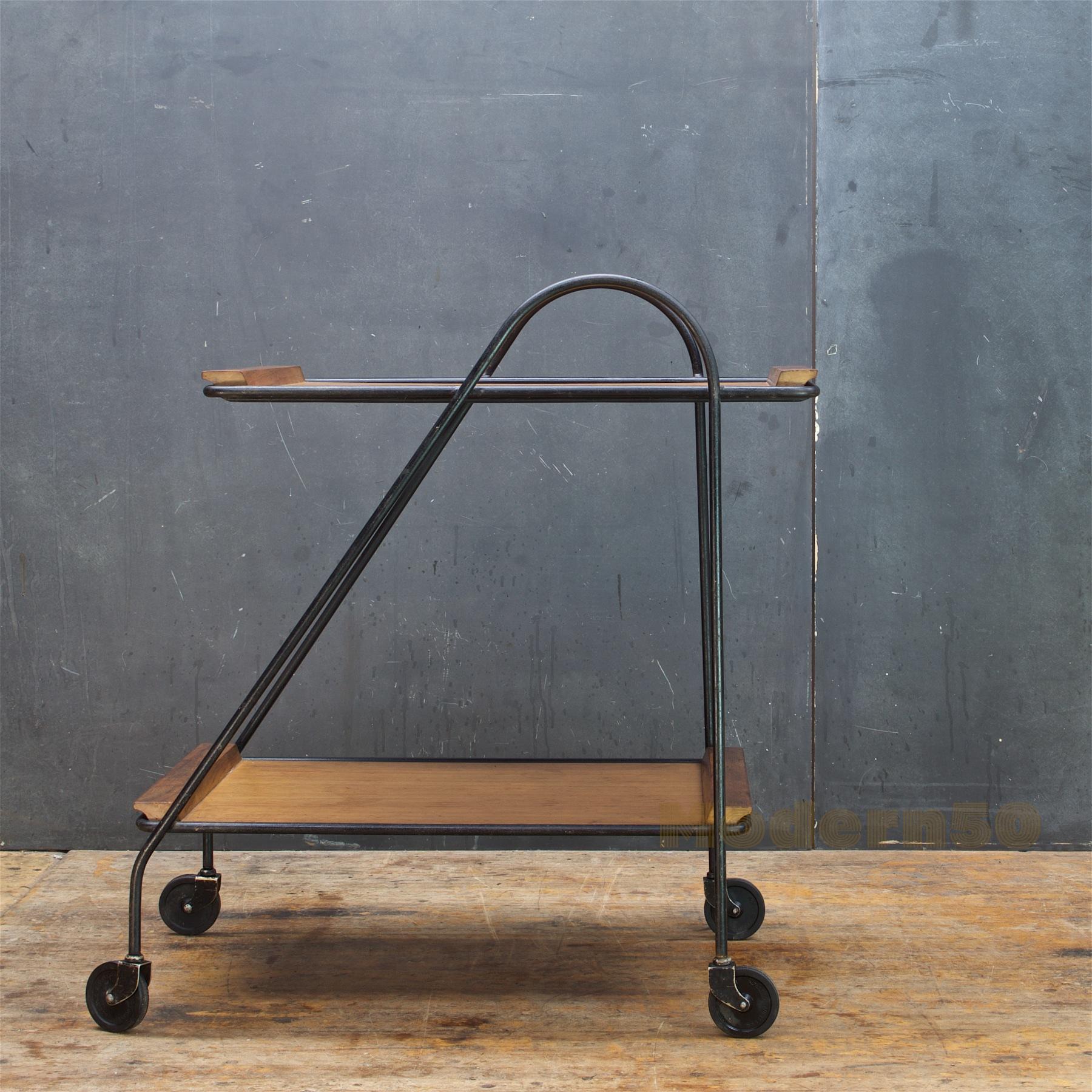 Design is attributed to Arthur Umanoff, but we have no reference. A very Minimalist Mid-Century Modern tea cart with two removable wooden trays. Shelf Heights; 9.25 and 27.5 inches. The trays are 18 x 27.