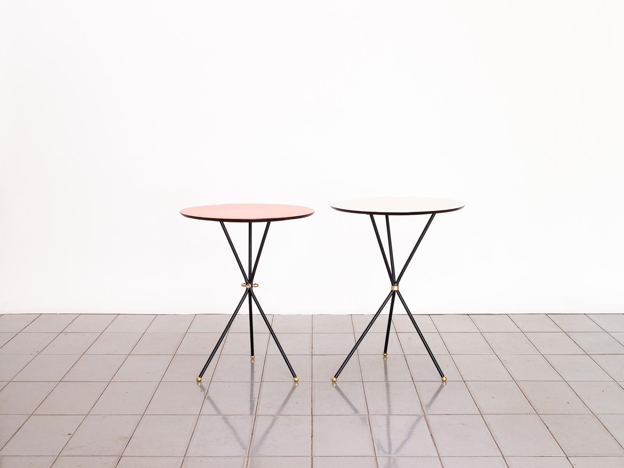 Delicate and super useful tripod side tables in Iron and Formica tops. The formica is in original condition but can be replaced to customer's taste. Brass details finish the touch. Perfect when having friends over for cocktails.