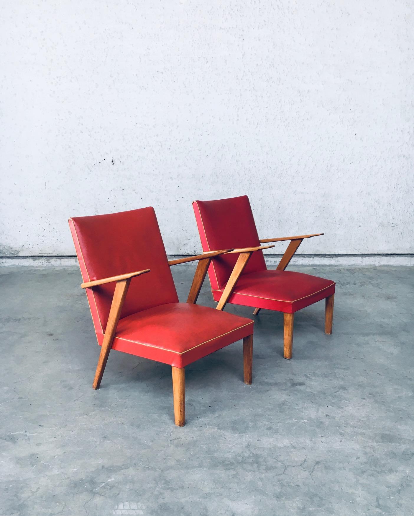 Vintage Midcentury Modern Dutch Design Lounge Chair set. Made in the Netherlands, 1950's. Faux leather, two different colors red skai with beech armrests and legs. The armchairs are similar, but differ slightly. The red skai fabric is different on