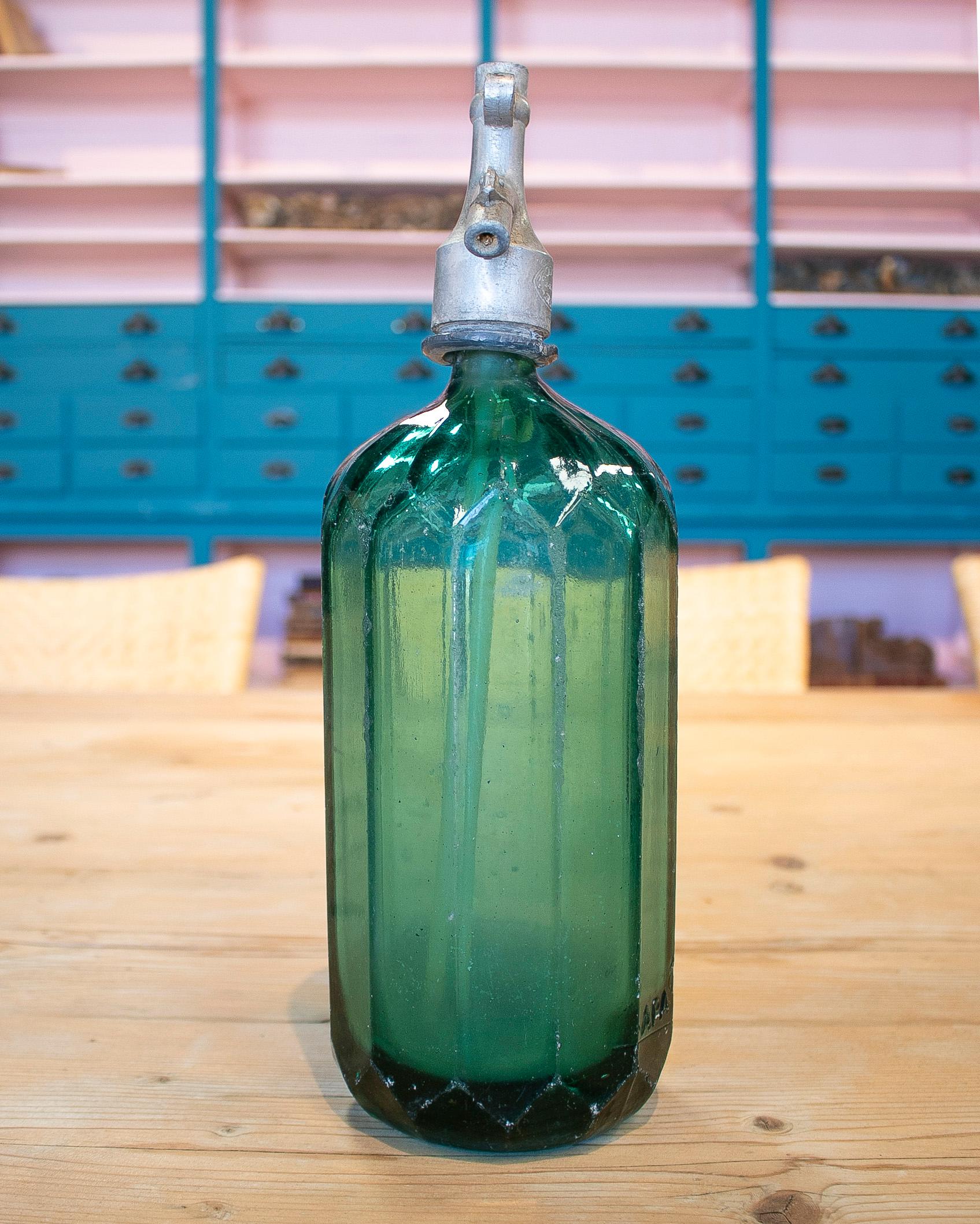 Vintage 1950s Dutch green glass soda siphon seltzer bottle with metal tap.