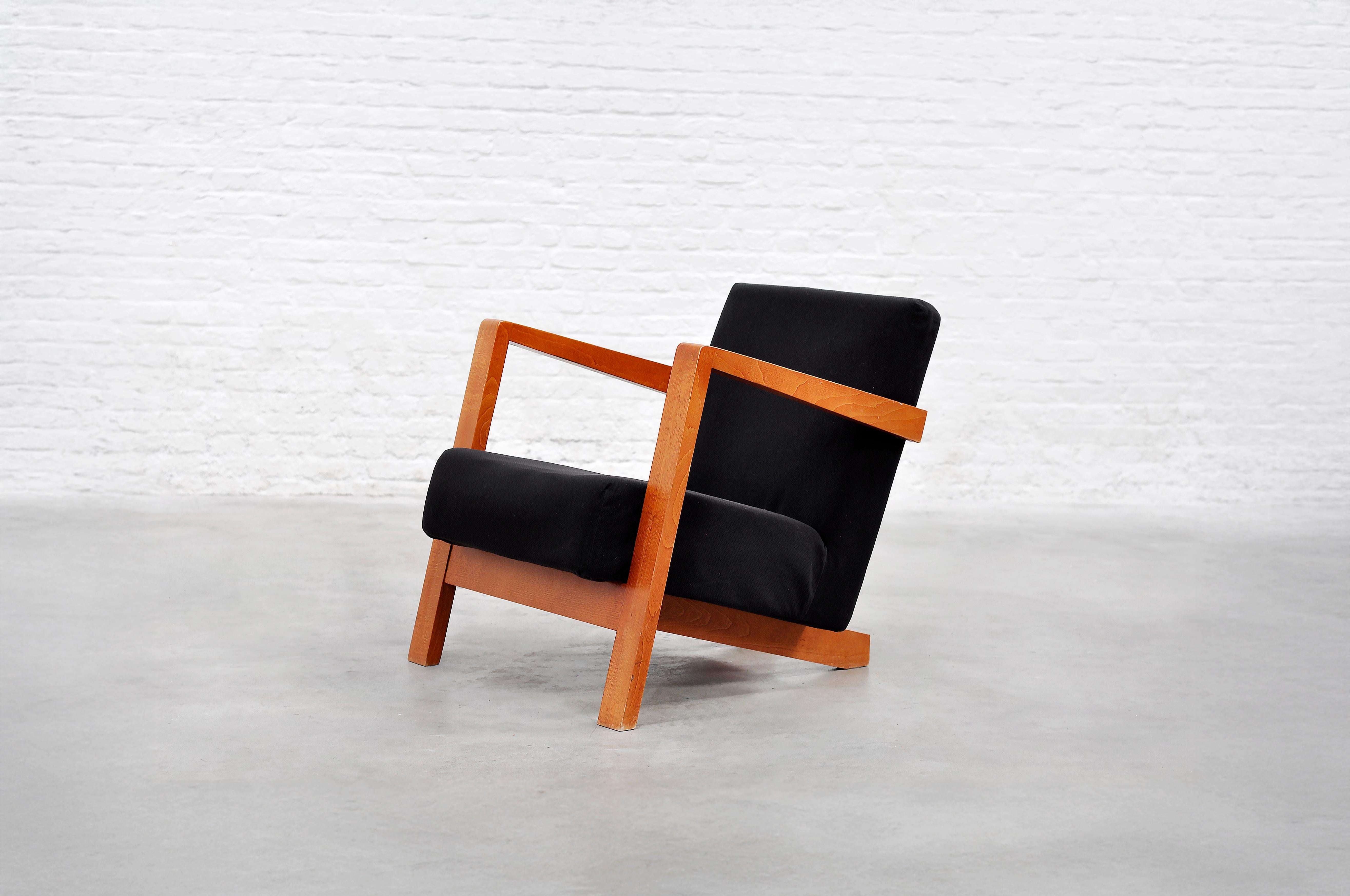 A striking example of Dutch modernist design, this low-profile armchair from the 1950s reflects the architectural precision and geometric rigor characteristic similar to Gerrit Rietveld’s work. The expertly crafted wooden frame features bold,