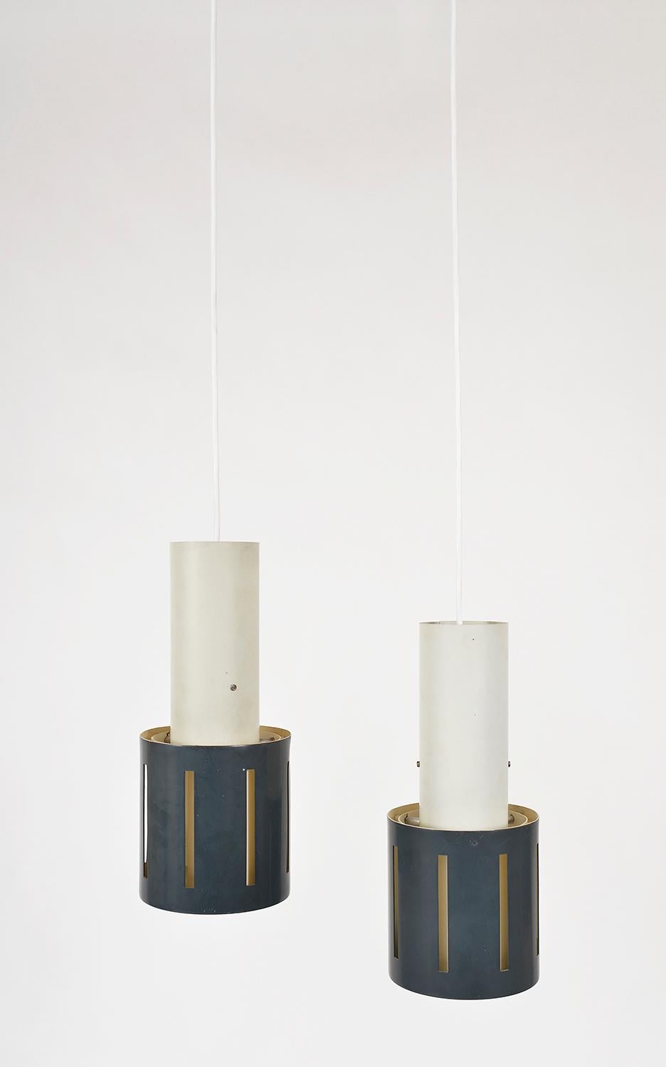 A very stylish pair of Dutch 1950s Mid-Century Modern anthracite blue cylindrical 'Hand Grenade' pendant lights. Hung from their original two piece steel ceiling rose, the wire runs down to a bulb holder located inside the white metal cylinder where