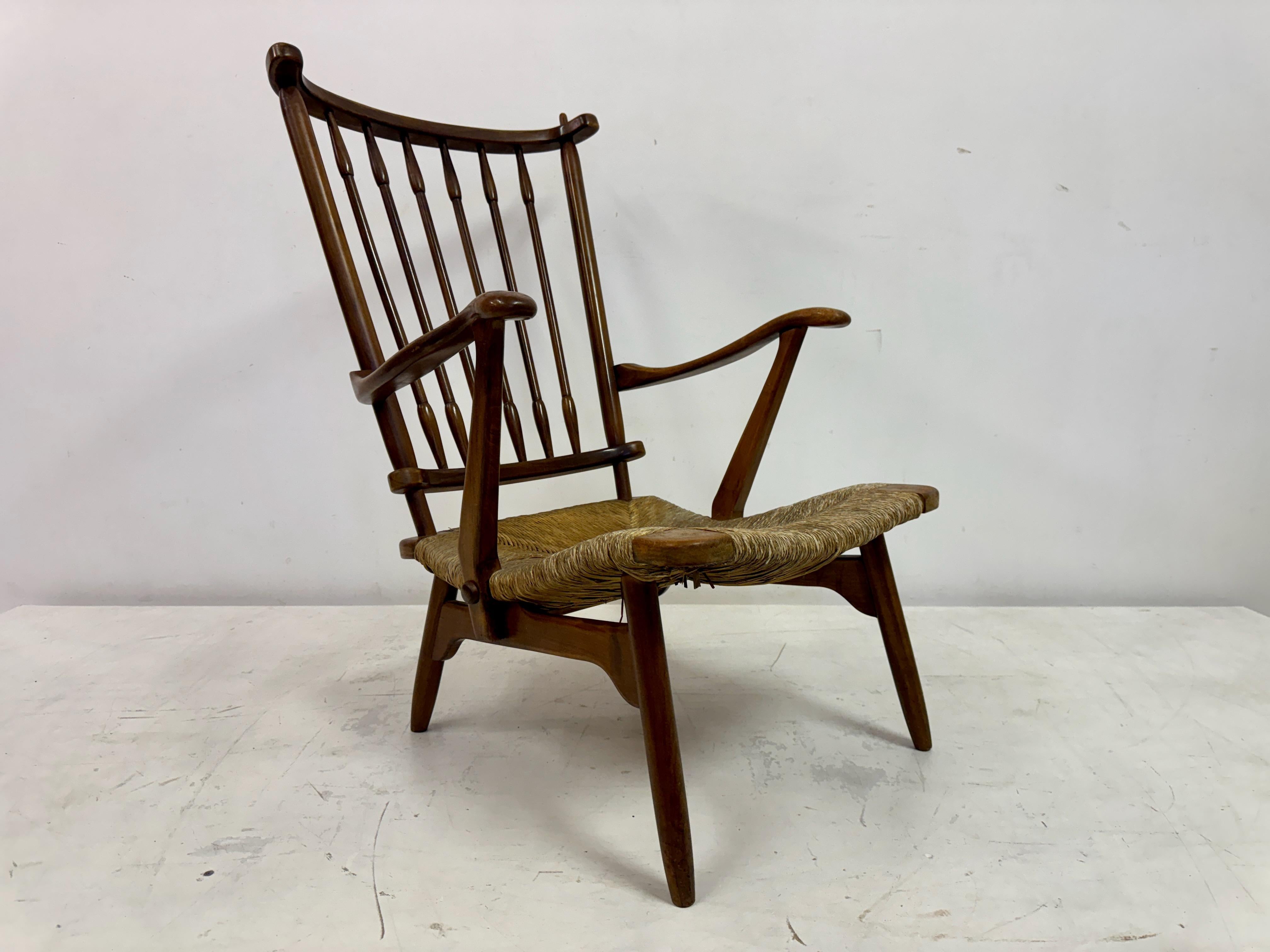 Armchair by De Ster Gelderland

Stick back and rush seat

Dutch 1950s

This armchair features a classic mid-century modern design with a Dutch influence. The high, gently curved stick backrest consists of evenly spaced spindles that provide both