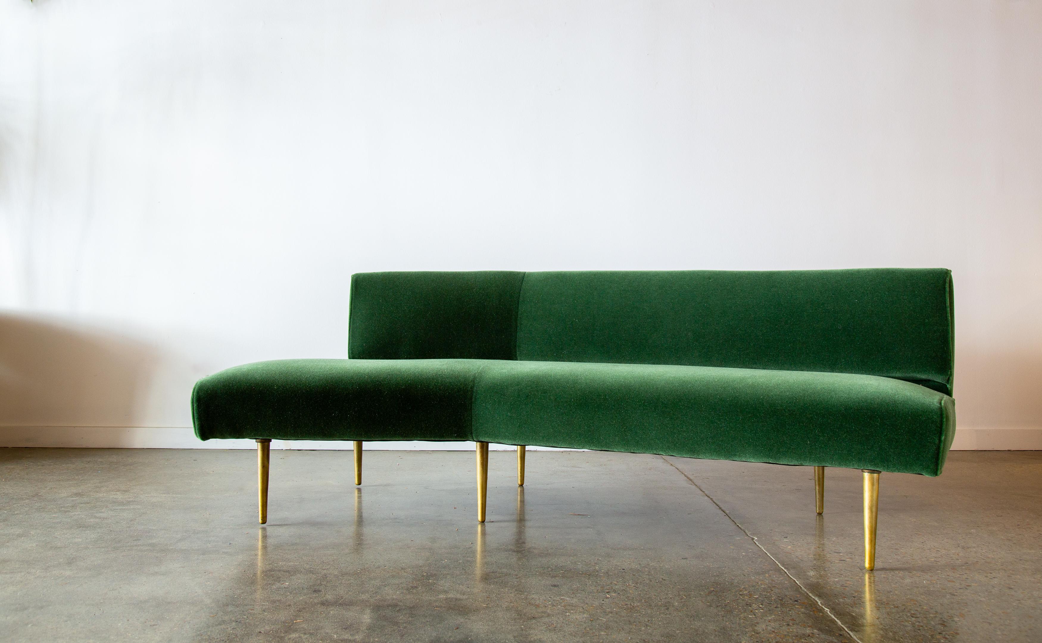 A rare offering from Edward Wormley for Dunbar Furniture. This wing shaped sofa, model 4756, was reupholstered in a moss colored mohair and sits on 10