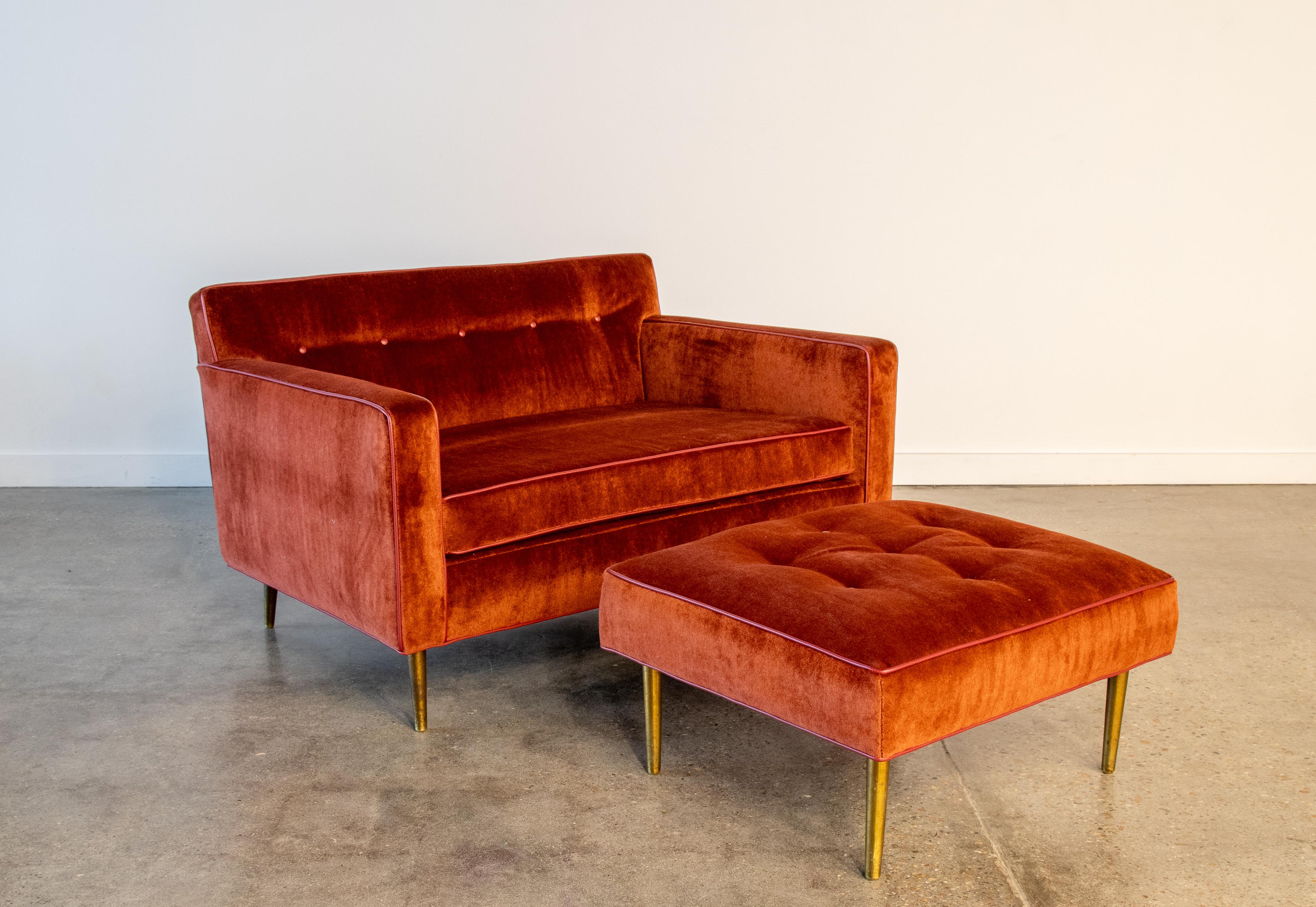 An extra wide cuddle sofa chair designed by Edward Wormley for Dunbar. Featuring brass legs and new foam and red mohair.  The red mohair is accentuated with maroon leather piping and buttons. The no sag straps and six way hand tied coil spring