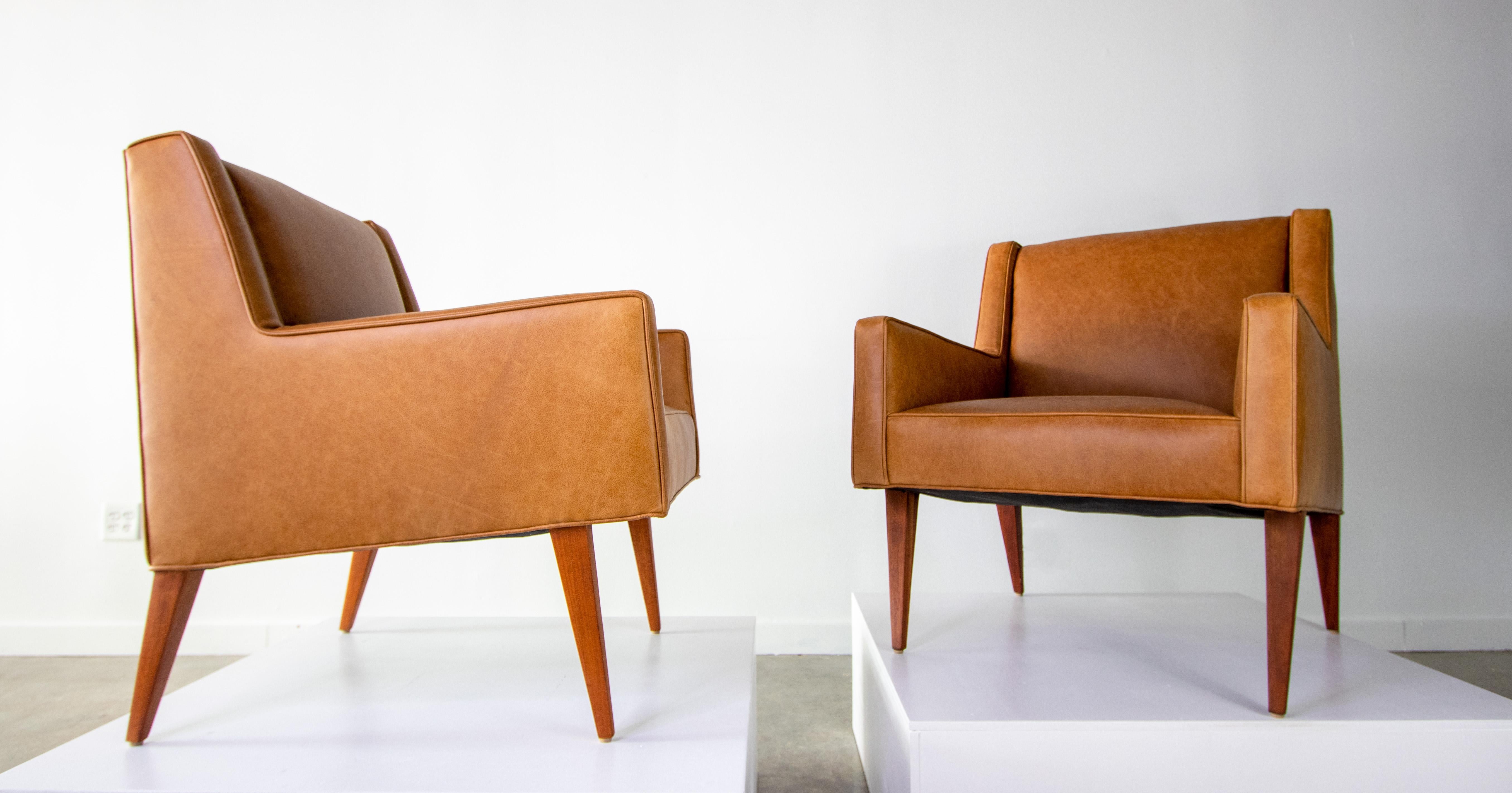 A pair of leather lounge chairs designed by Edward Wormley for Dunbar vintage from the 1950s. These chairs are model 603 and were called the Mrs. Chair in the original catalogue. Higher legs and a more prim and proper look than its mate the Mr.