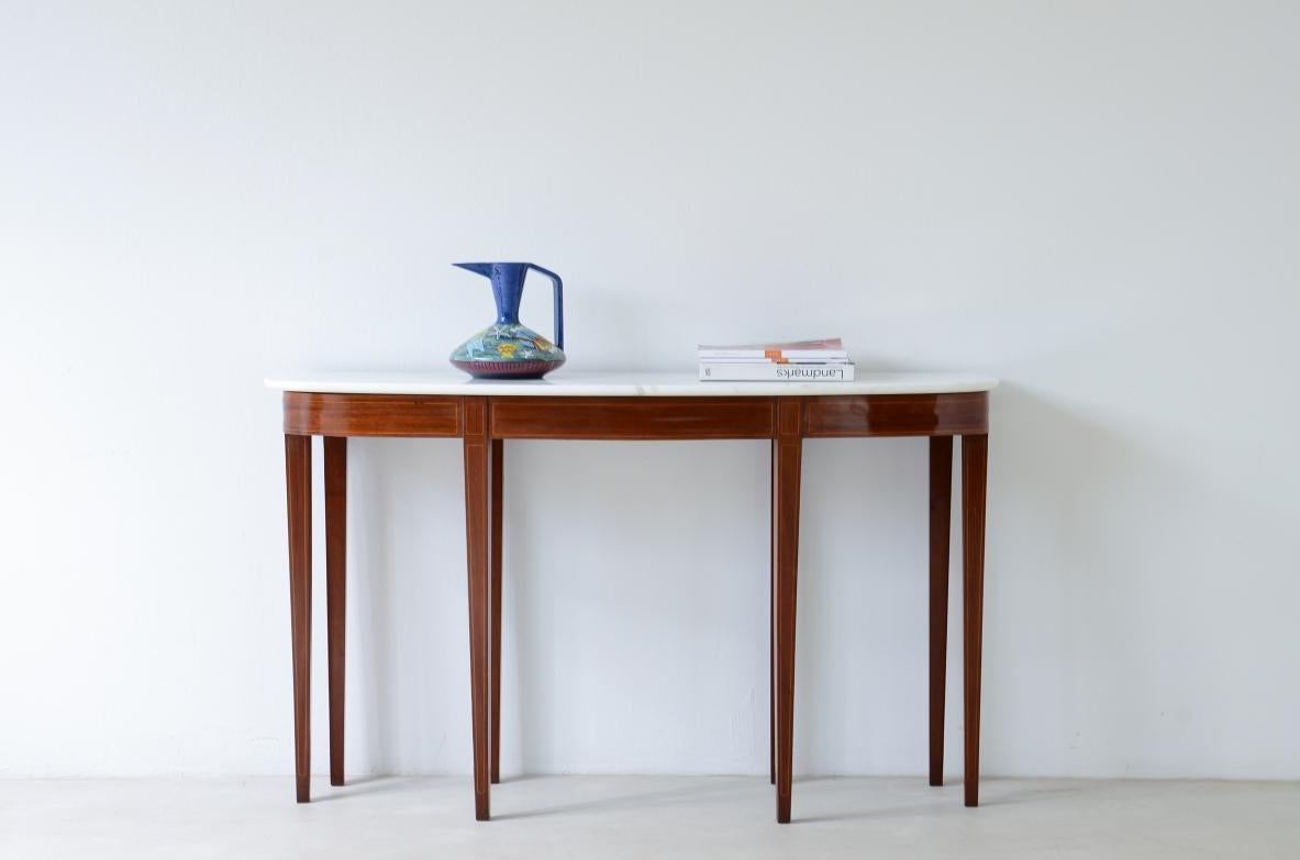 
COD-2733
Elegant console with eight tapered legs and Carrara marble top.

Italian manufacture, ca.1950s.