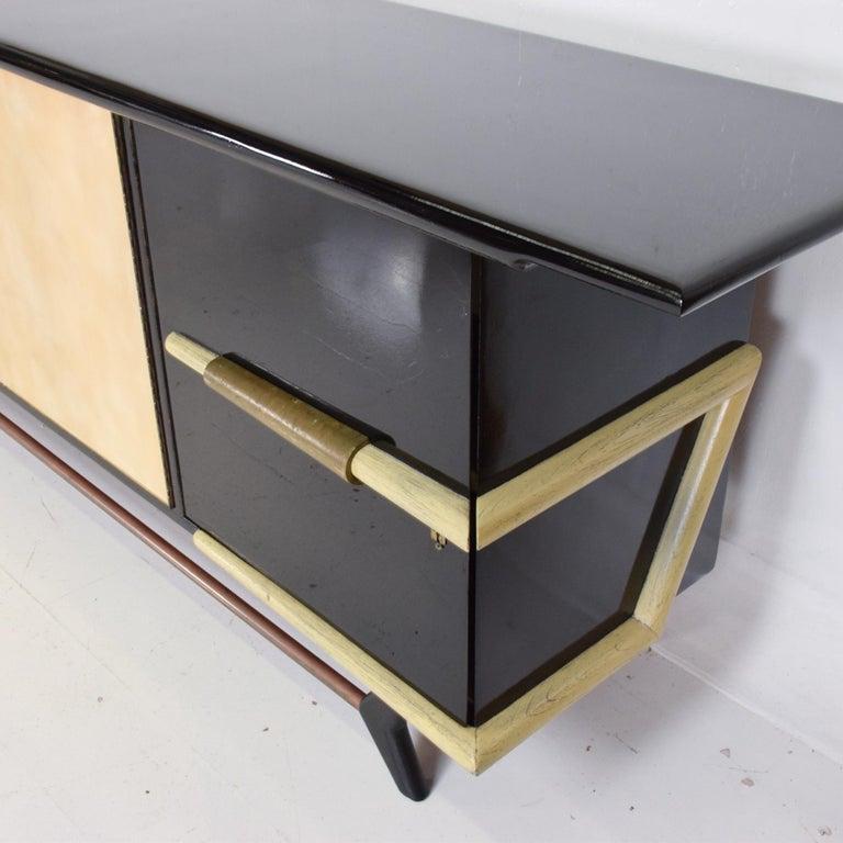 1950s Mexican glamour dramatic credenza cabinet mahogany with custom black lacquer finish 
Fabulous and ready to go!
Unmarked attributed to Eugenio Escudero. 
Center doors in goatskin. Bronze accents and original patina.
Doors feature Pepe Mendoza