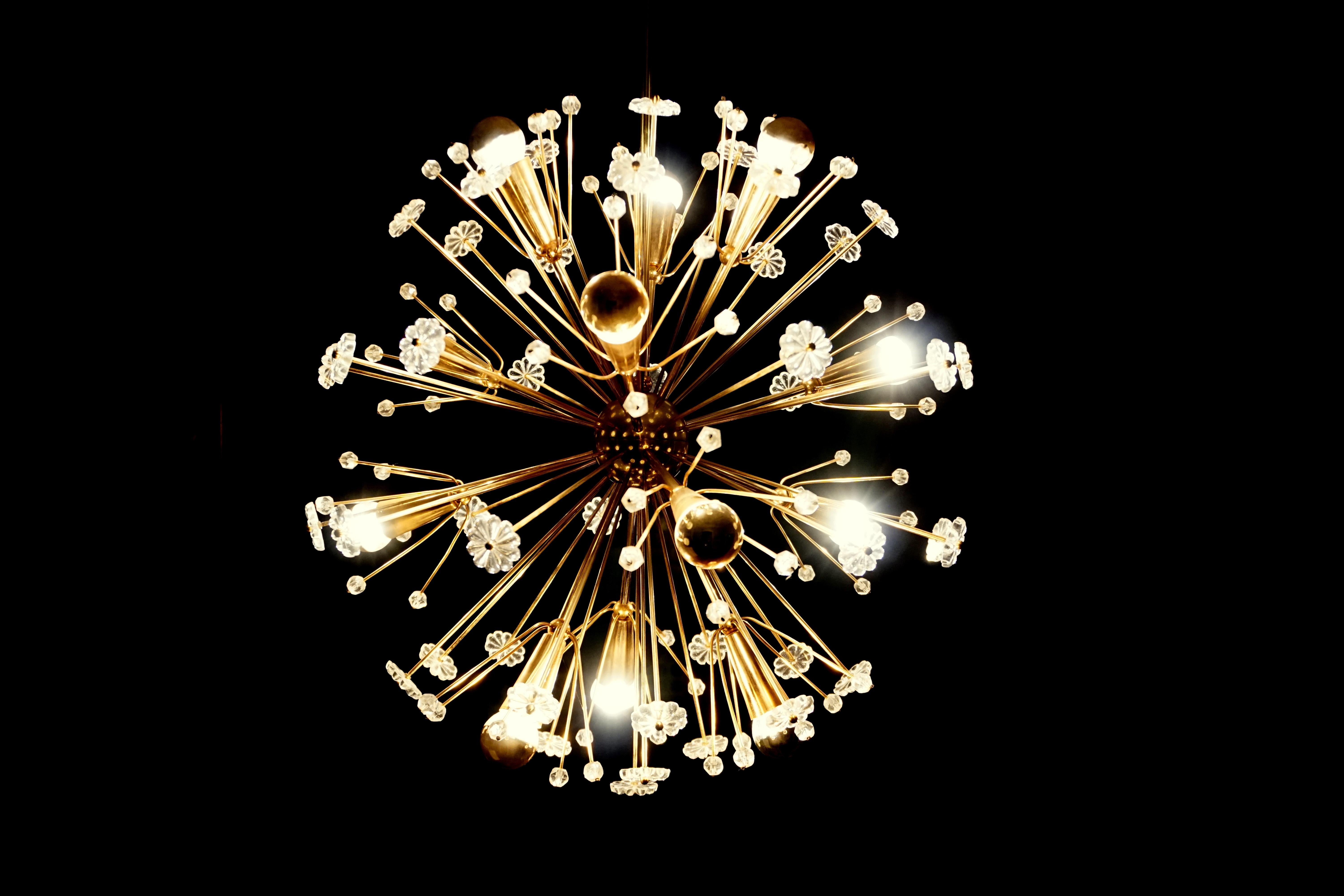 A rare and elegant Version of the iconic Snowflake Chandelier from austrian Designer Emil Stejnar for Rupert Nikoll, Vienna.
This very early and elegant chandelier has the nice conical-shaped gilt Brass sockets for the 12 bulbs .
Later versions