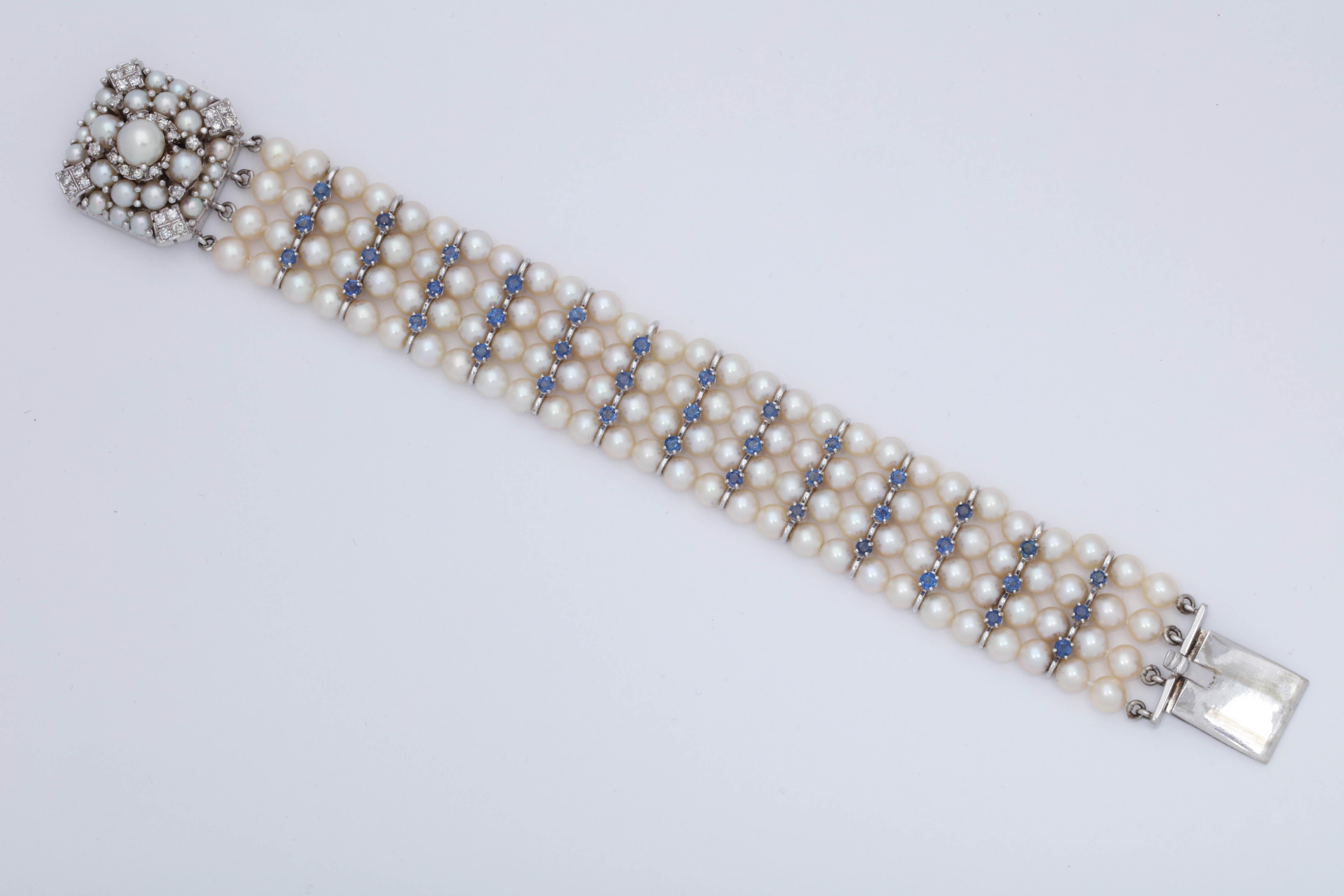 One Ladies Flexible 14kt White Gold Bracelet Embellished With Numerous 5Mm Cultured Pearls. Bracelet Also Designed With 39 Faceted Sapphires And With Numerous Diamonds On Clasp Weighing Approximately One Carat Total Weight. Created In The United