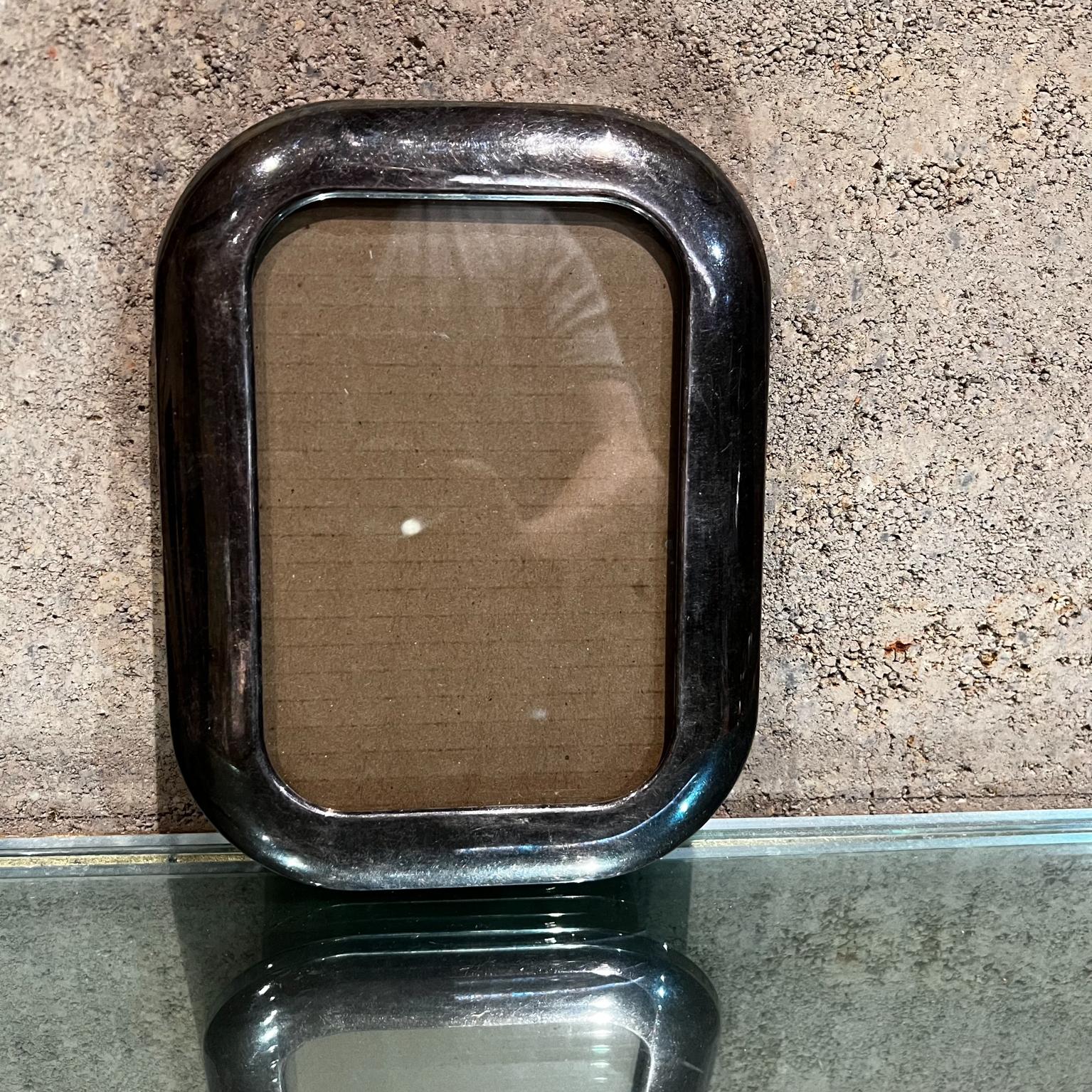 1950s Elegant silver plate vintage picture frame
Rectangular shape 
New glass. 
Black velvet finish on the back. 
Unmarked
Measures: .75 thick x 8.5 x 6.5 (will take 6.5 x 4.5 pictures)
Preowned original vintage condition.
Please Refer to