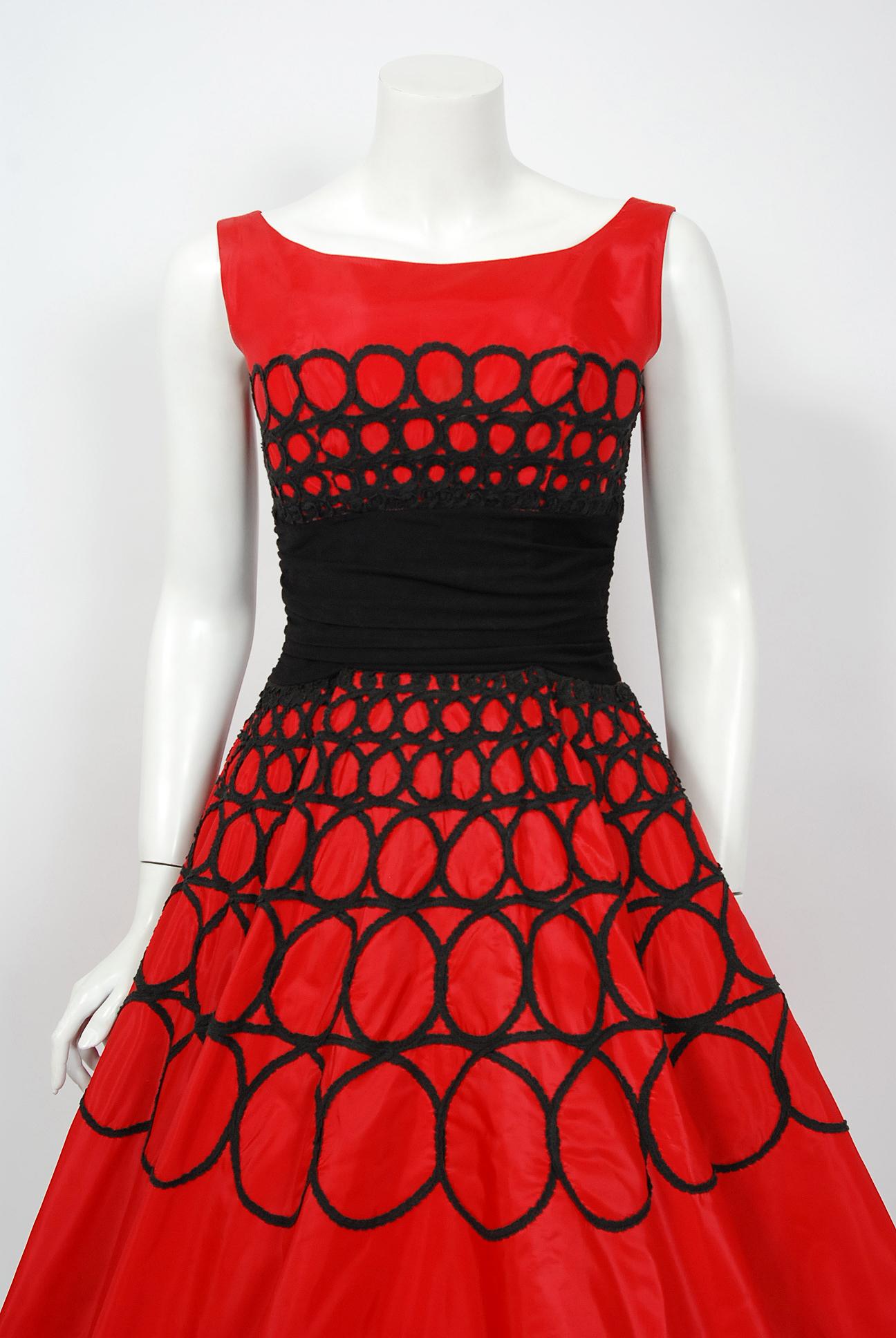 This is such a dramatic and romantic 1950's party dress. Perfect for any upcoming party; you can't help but feel feminine in this beauty. Valentine's Day perfection! The garment is fashioned from a stunning ruby red taffeta with black embroidered