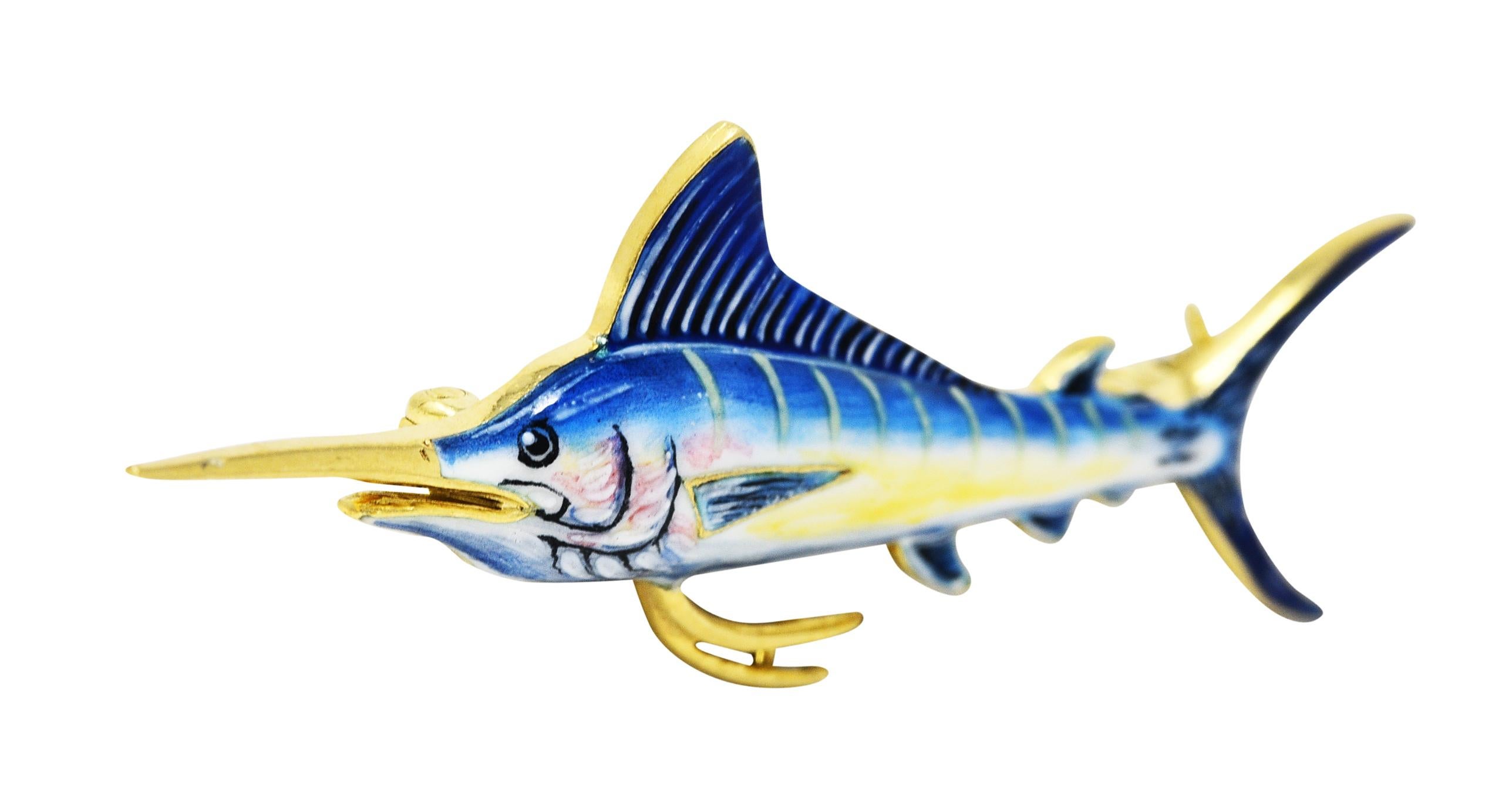 Bar brooch is designed as a stylized marlin fish

Glossed with opaque enamel - exhibiting loss consistent with age and use

Bright ultramarine blue fins to a pastel yellow streaked stomach

Completed by a pin stem with locking closure

Tested and