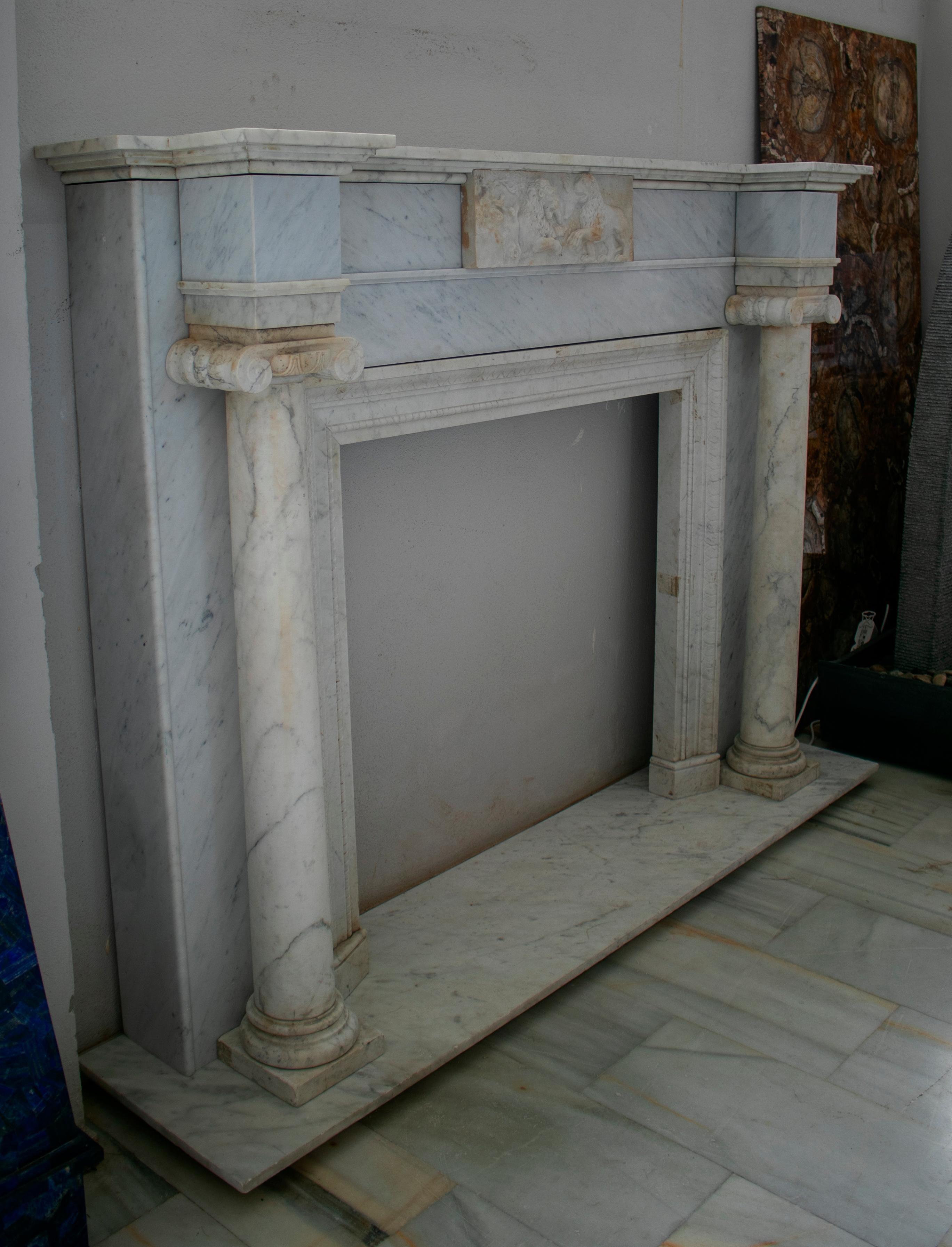 1950s English hand carved white marble fireplace flanked by a pair of ionic columns.

Interior measurements: 101 x 105cm.
    