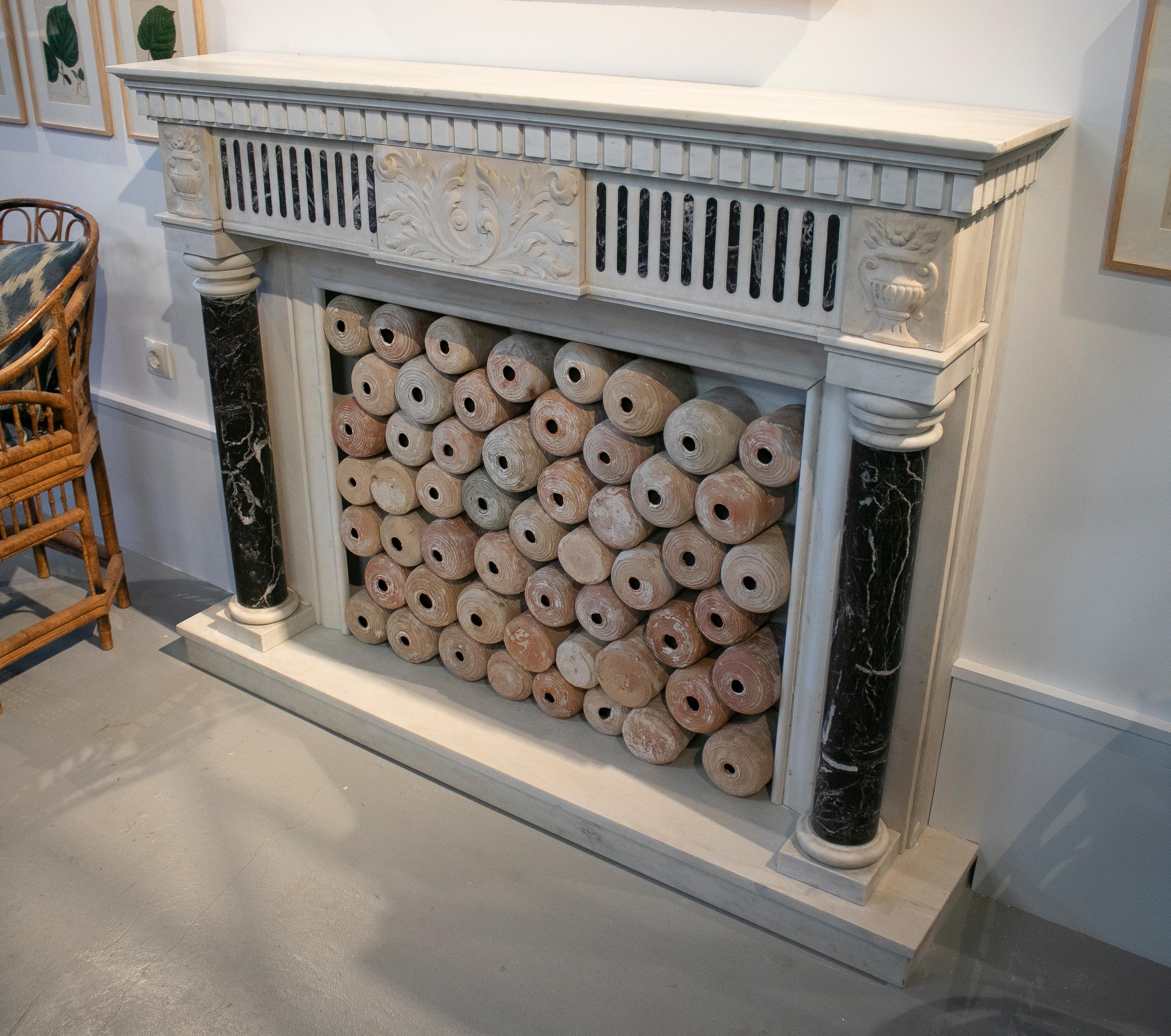 1950s English hand carved marble fireplace with ionic columns.