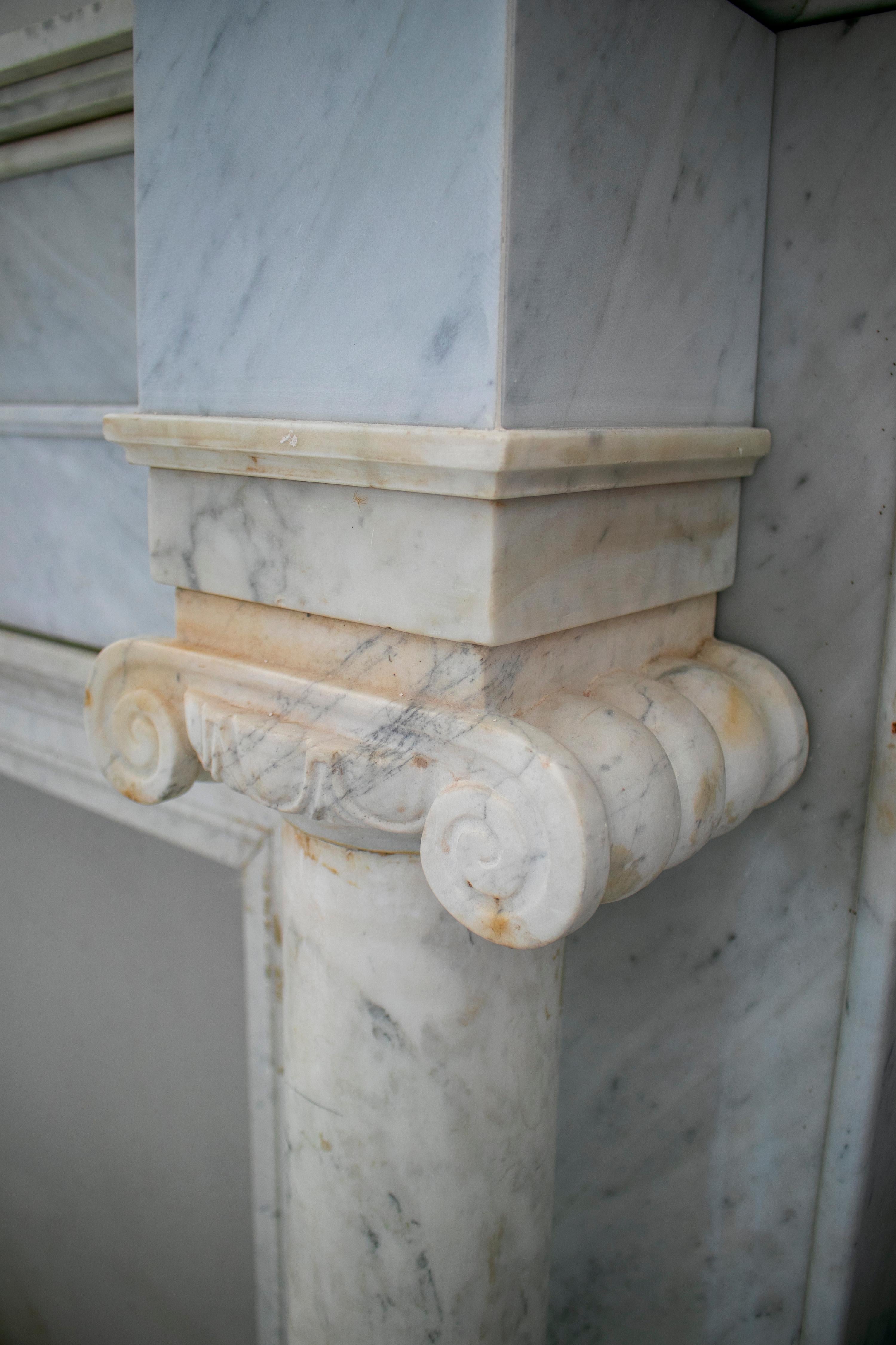 Hand-Carved 1950s English Hand Carved Marble Fireplace with Ionic Columns For Sale