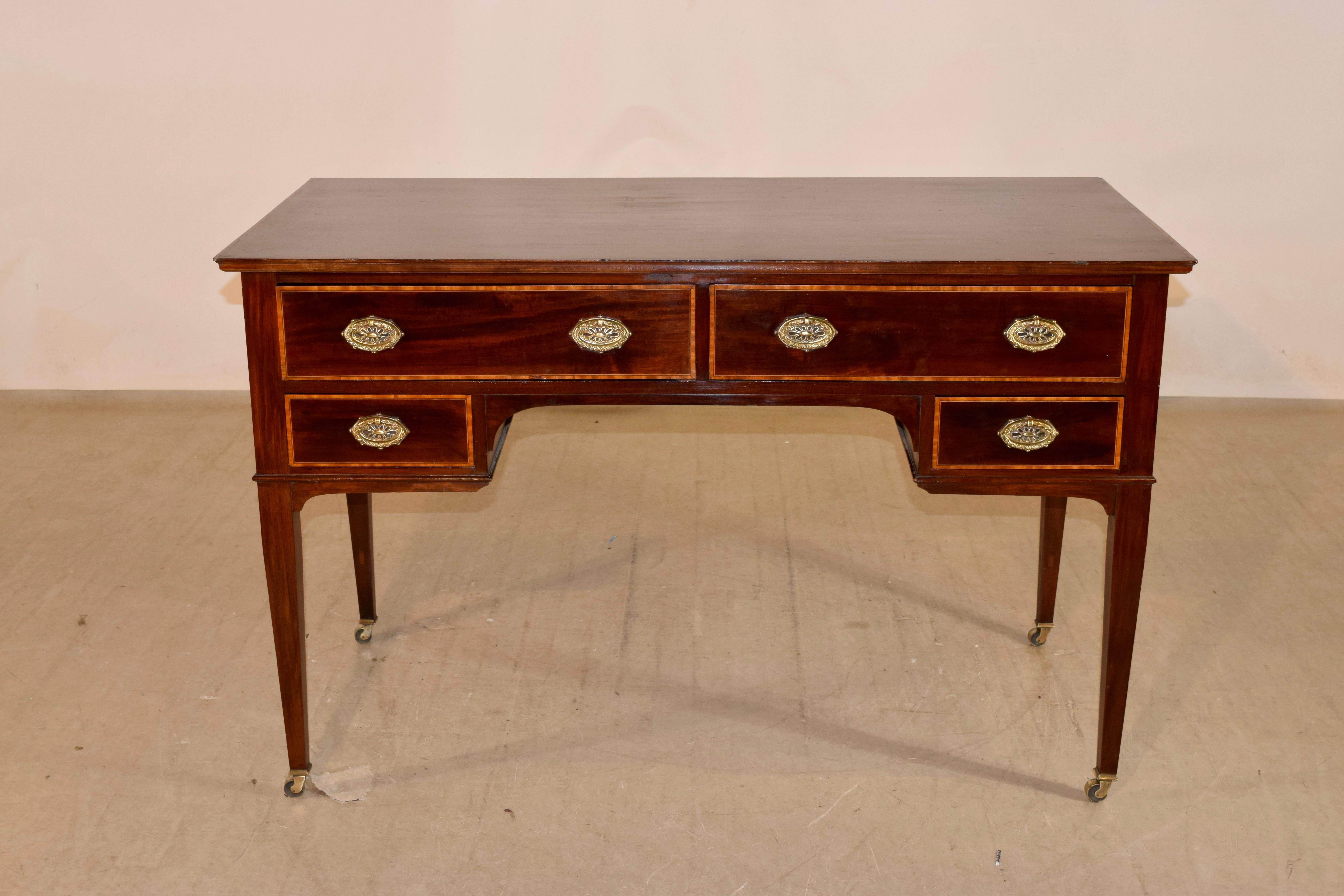 Mid-20th-century mahogany desk with satinwood inlay. The top is wonderfully grained and is made from two boards, banded in satinwood. The sides are simple and also have gorgeous graining. The front of the desk contains four drawers, also banded in