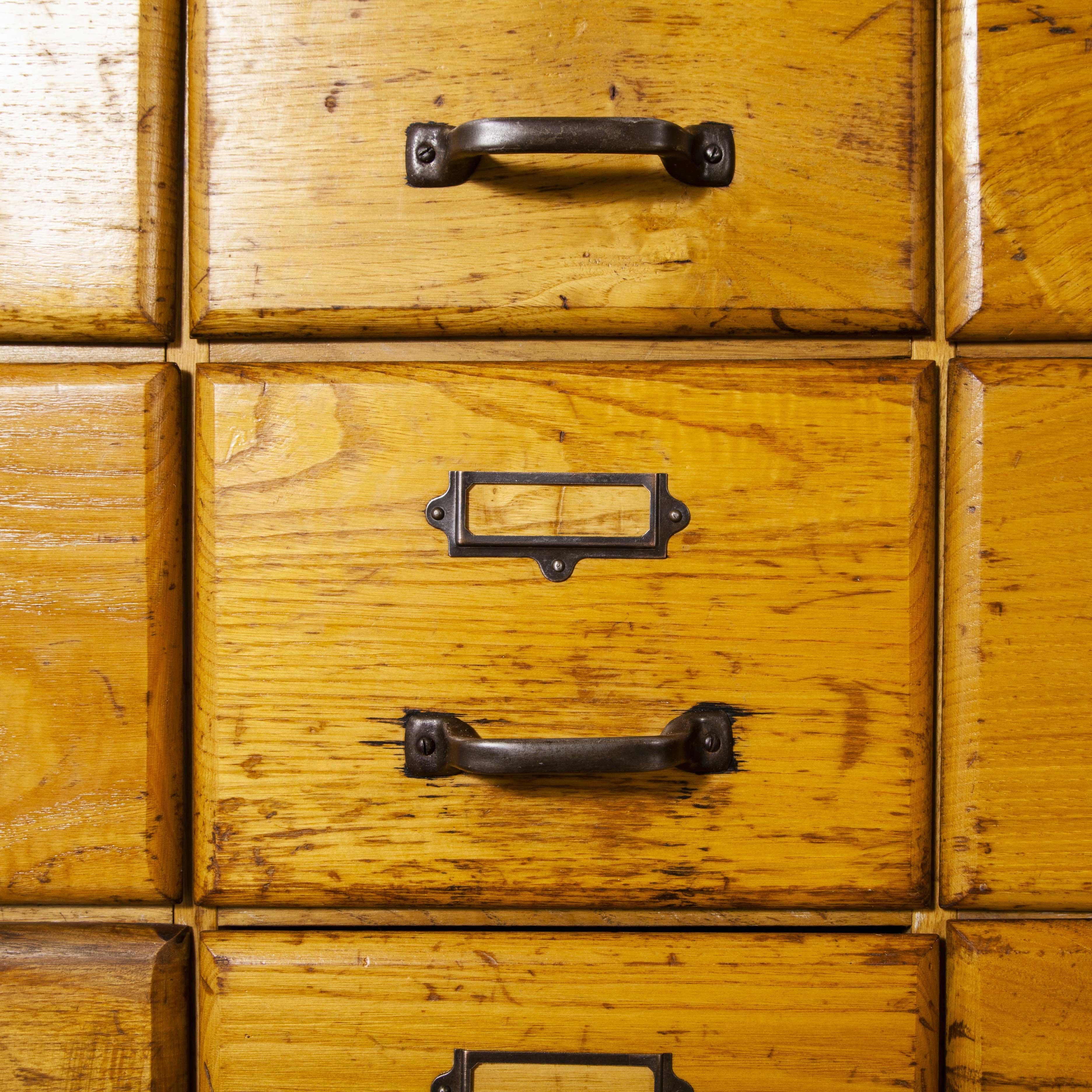 1950s English oak tall multi drawer chest of drawers – Twenty one drawers

1950s English tall oak multi drawer chest of drawers – twenty one drawers. We recently salvaged a whole collection of original haberdashery shop cabinets from the original