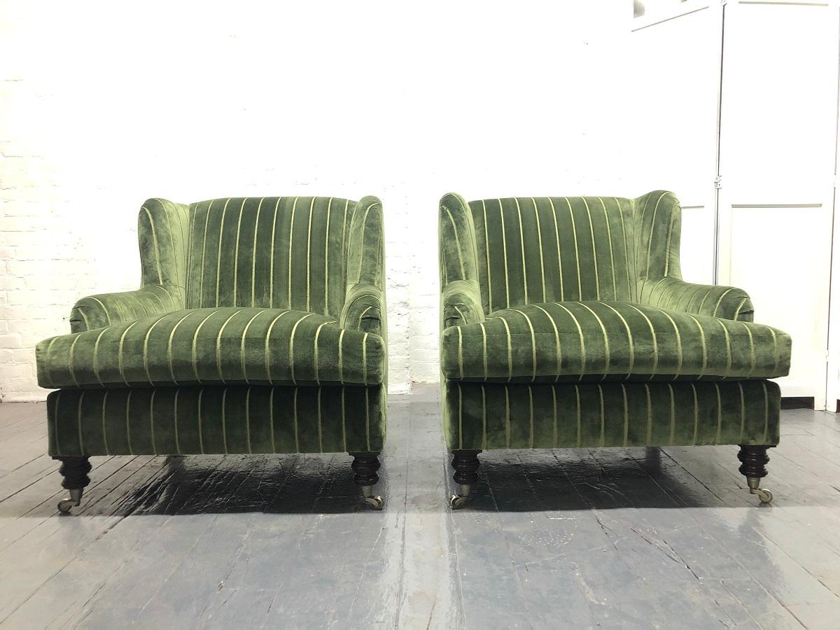 1950s English upholstered lounge chairs. The chairs have solid walnut legs, original casters and completely restored and upholstered.