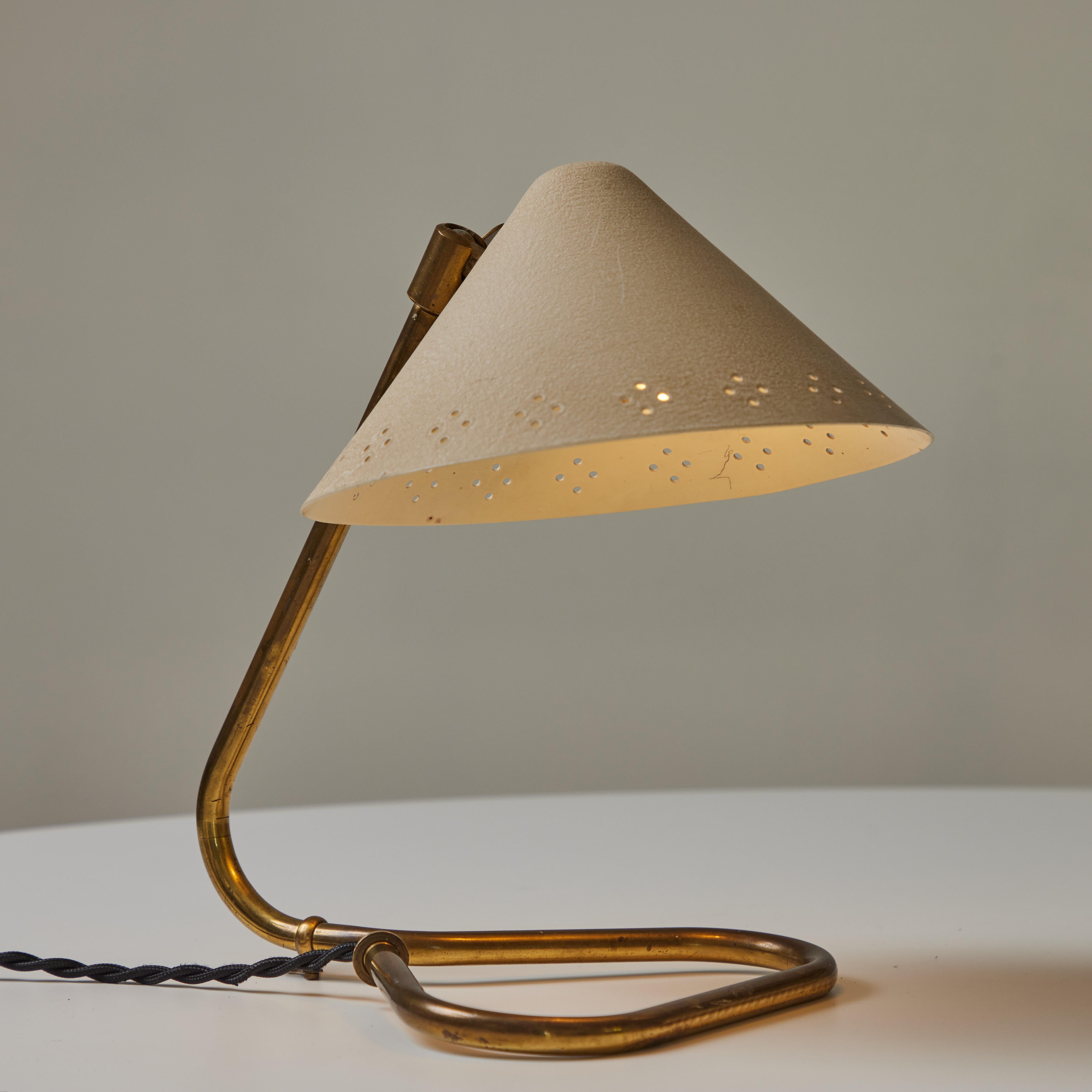 1950s Erik Warna 'GK14' Perforated Shade Table Lamp. Executed in perforated painted metal and patinated brass. Shade is adjustable and can be rotate up or down. Produced by Gnosjö Konstsmide Rydahls in Sweden in the mid-century. A highly refined