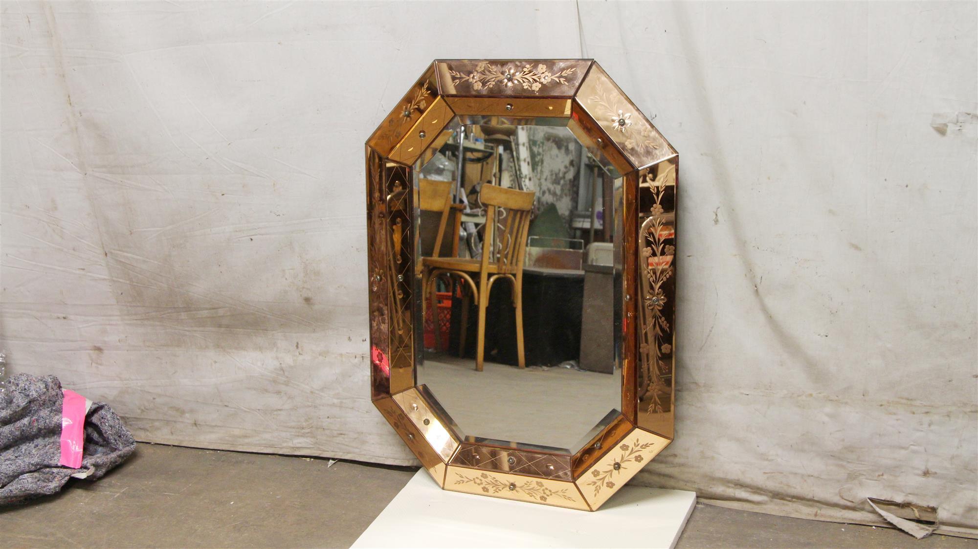 Copper colored glass mirror with etched floral details, circa 1950s. This can be viewed at one of our New York City locations. Please inquire for the exact address.