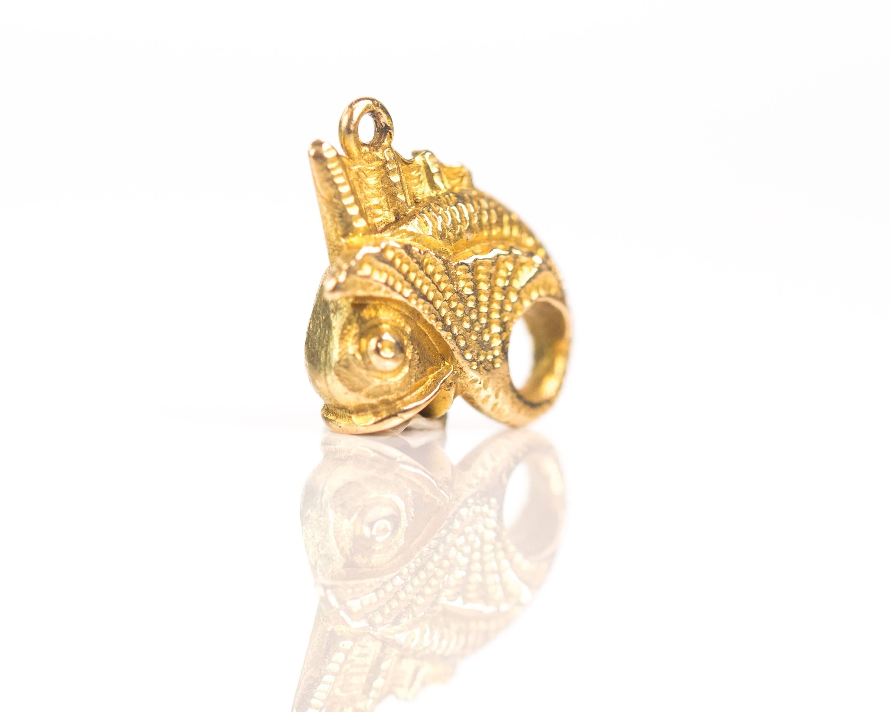 1950s Eternal Circle Fish Charm - 9 Karat Yellow Gold 

This exquisitely detailed Fish Charm is crafted from 9 Karat Yellow Gold. The fish is curved into a circle. The mouth is open and the two round eyes seem to pop just in front of the gills. A