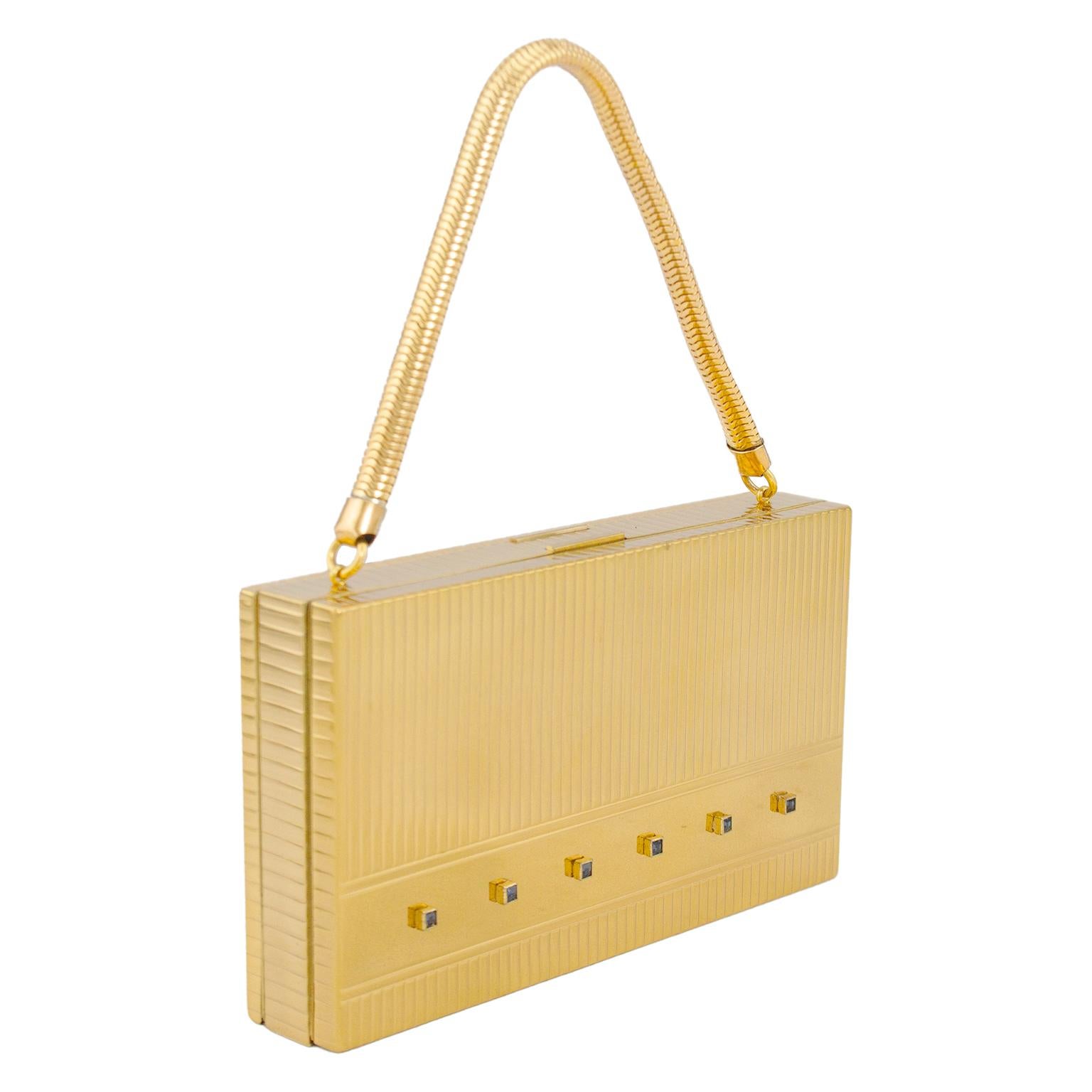 Before mobile phones, the favorite evening bag of the 1950's socialite was a hard case Evans Case Co. minaudiere with efficient compartments for the must haves of the night; lipstick, powder, comb, cigs, a mirror and some coins for the attendant in