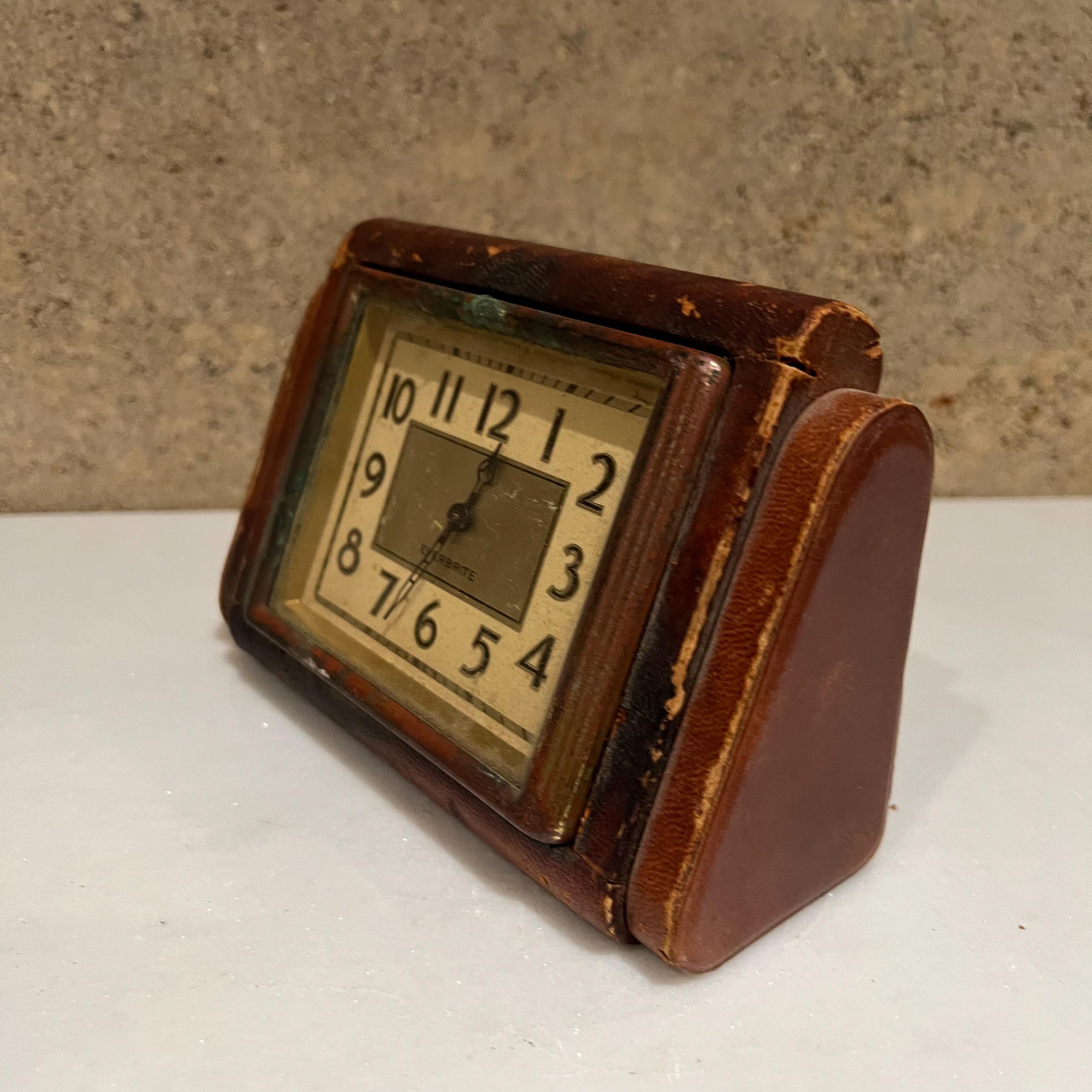 1950s USA Everbrite desk table clock wrapped in leather.
Fabulous looking vintage clock in distressed condition.
Measures: 4 tall x 6.25 width x 2.5 depth
Preowned vintage unrestored condition. Not in working order. 
Selling as decorative piece