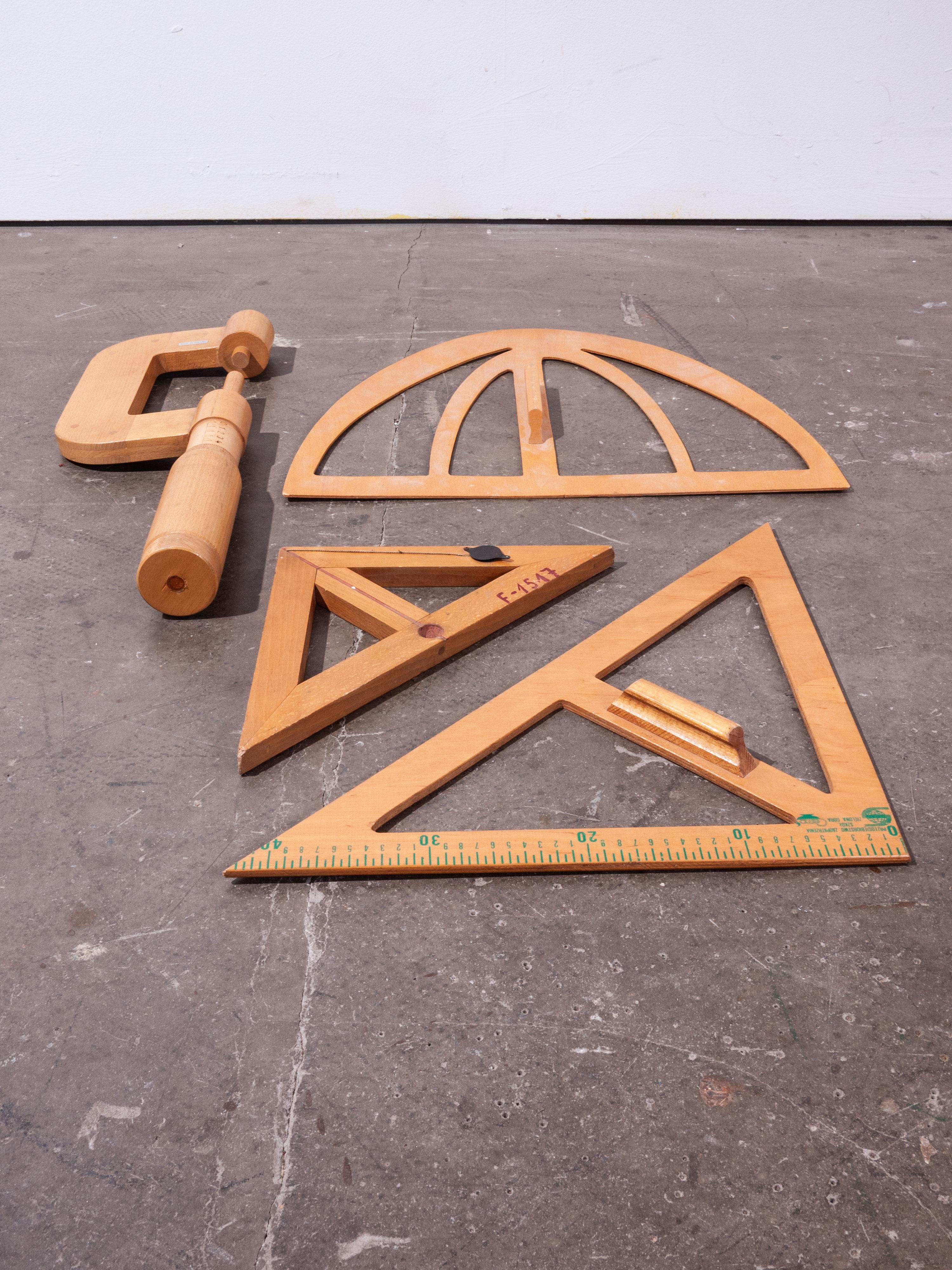 1950s extra large wooden measures set, four pieces

1950s extra large wooden measures set. Featuring an oversize Vernier calliper set and three blackboard geometric drawing shapes. Oversize callipers measure 56 cm in length and are fully