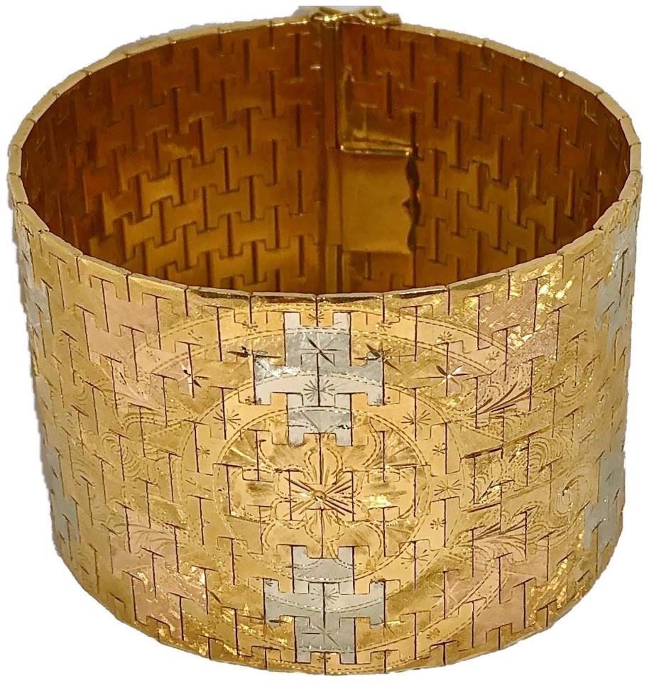 Many of these lovely and intricately detailed 18k Florentine bracelets were created in jewelry centers in Europe and in the United States during the 1950's. However, this one is most unusual in that it is extremely wide, measuring a full 1 3/4
