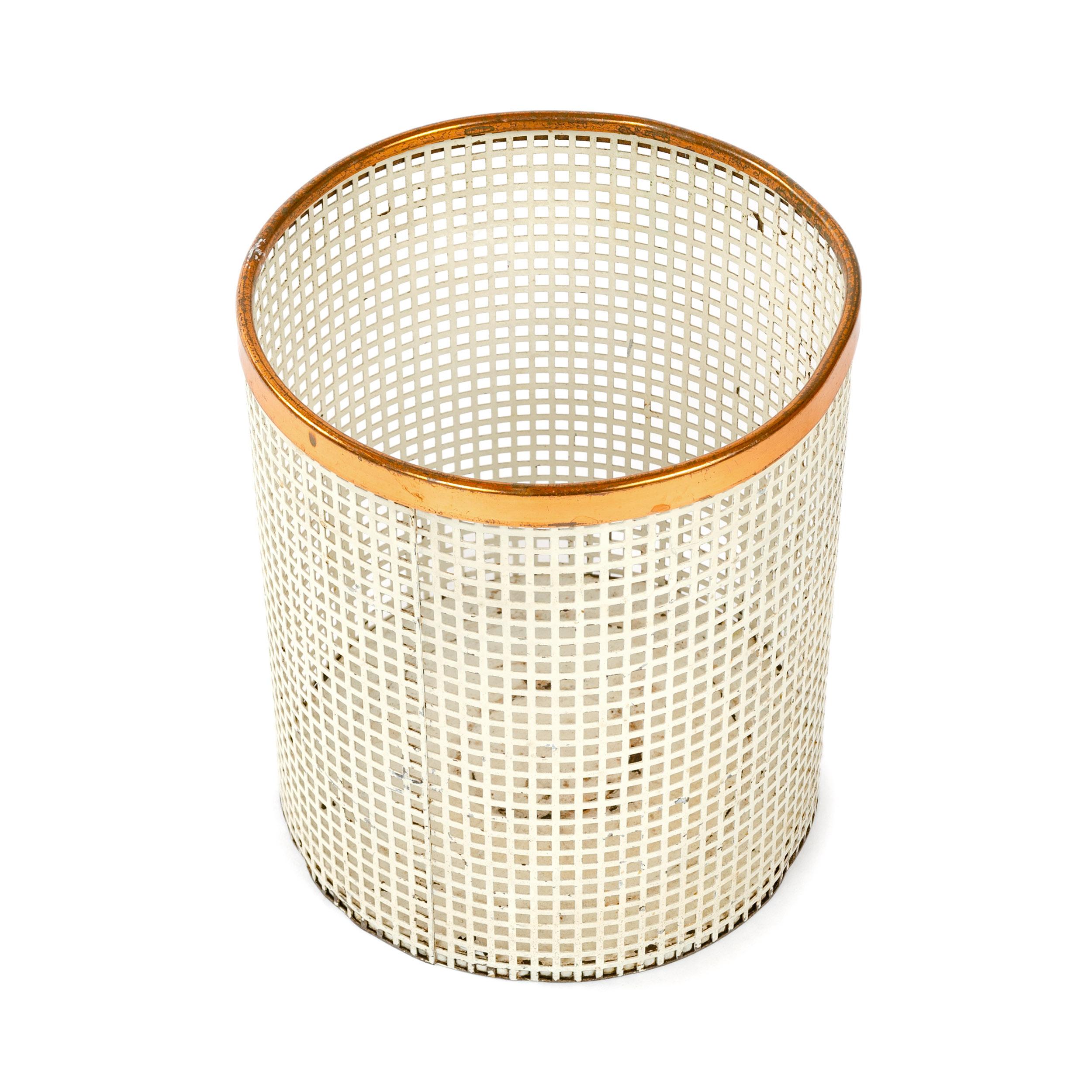 A Josef Hoffmann/Weiner Werkstatte inspired circular waste receptacle of formed, extruded steel in a white enameled finish and copper band around its rim.