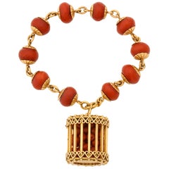 1950s Faceted Oxblood Coral with Coral Beads in a Cage Charm Gold Link Bracelet