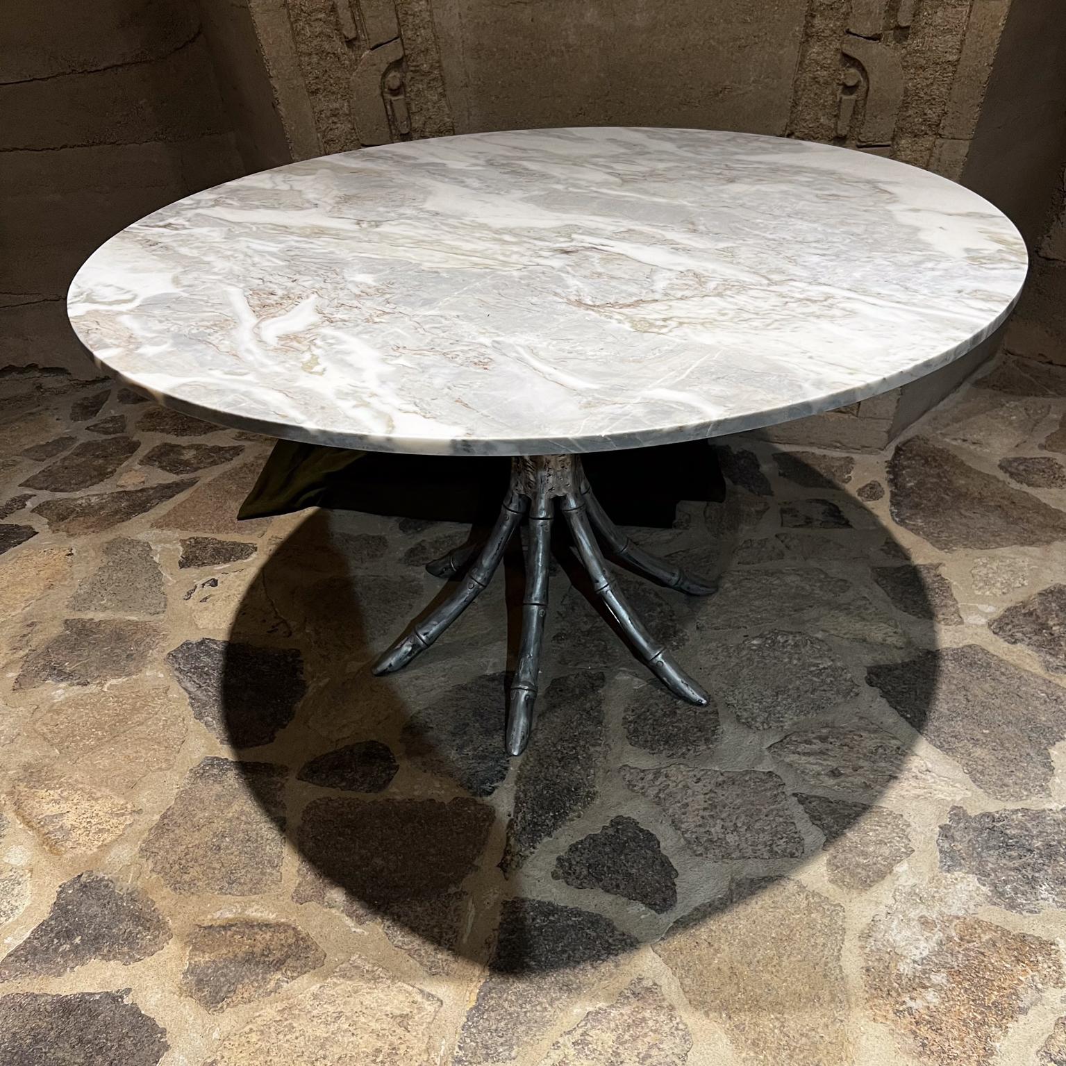 Hollywood Regency Faux Bamboo Aluminum Pedestal Dining Table Marble Top
Made in Mexico late 1950s.
No stamp
29.5 H x 48 in diameter, base 25.5 in diameter
New marble top. Raw aluminum, scuffs present.
Expect signs of vintage wear.
Refer to images.