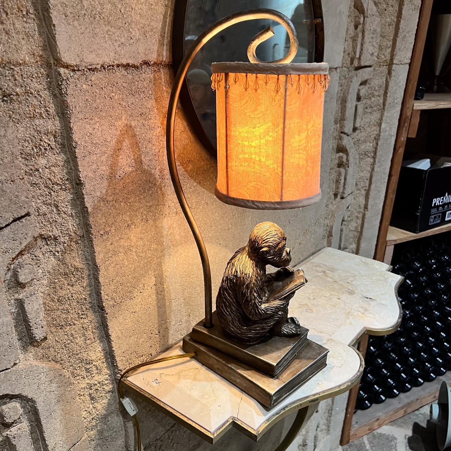 AMBIANIC presents
1950s Faux Bronze Table Lamp Chimp Monkey Sculpture Reading Book
in the style of Maitland Smith
22 h x 6 w x 9.25 d, shade 7.25 x 6 diameter
Original vintage condition, lamp is shade included.
Refer to images provided