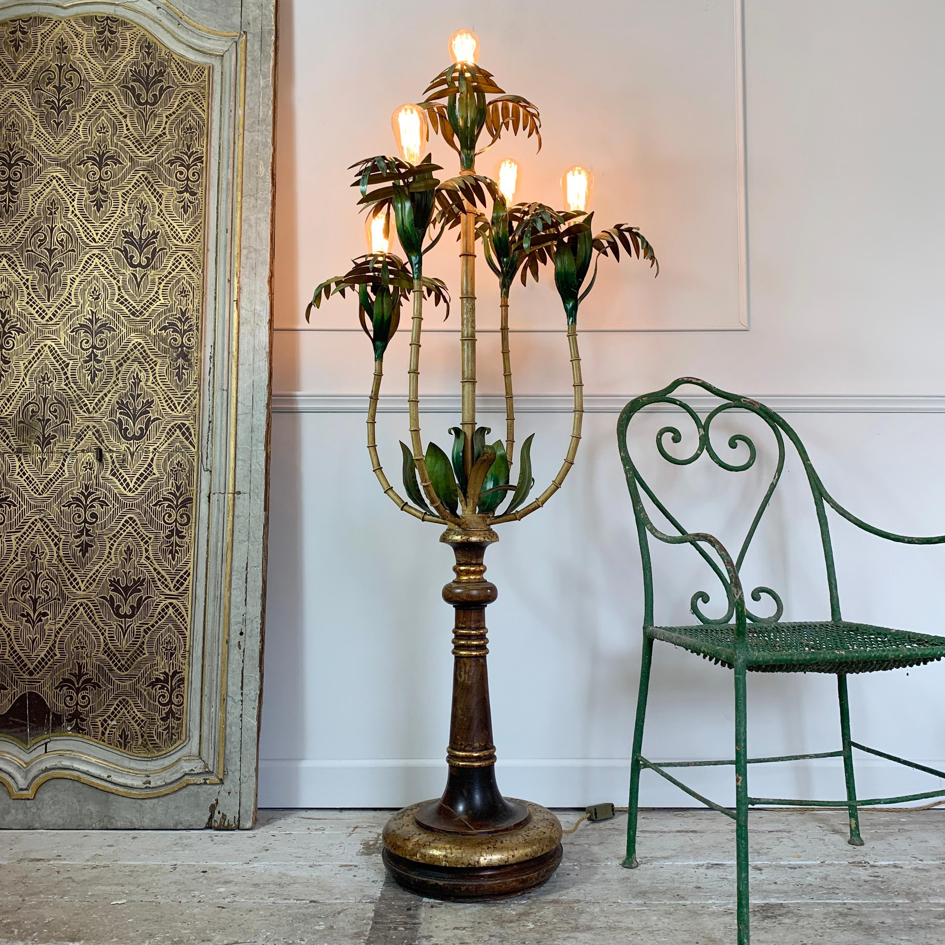 Rare and beautiful Italian 1950s tole floor lamp
This lamp is stunning and a large statement piece the top of the lamp is faux metal bamboo stems and palm leaf design
The base is beautifully carved solid wood with gilt detailing
There is