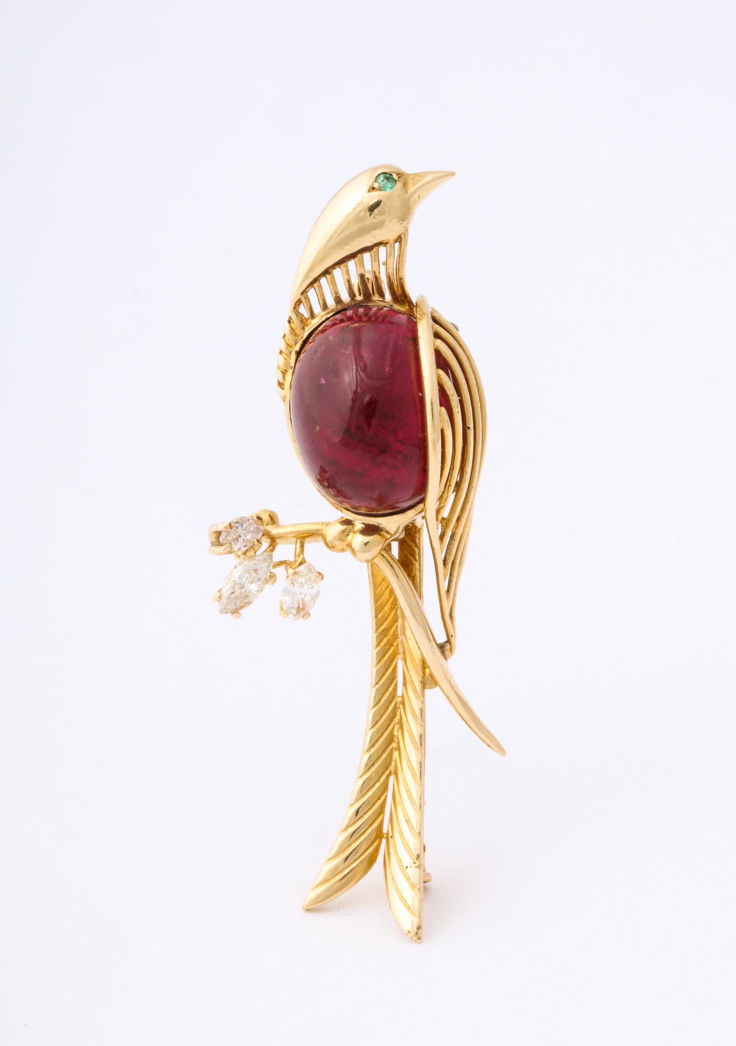 One Ladies 18kt Yellow Gold Canary Bird Brooch Designed With One Large Cherry Color Cabochon Rubelite Measuring Approximately 16Mm. Bird Brooch Is Further Embellished With Three Marquis cut Diamonds Weighing Approximately .45Cts Total Weight. One