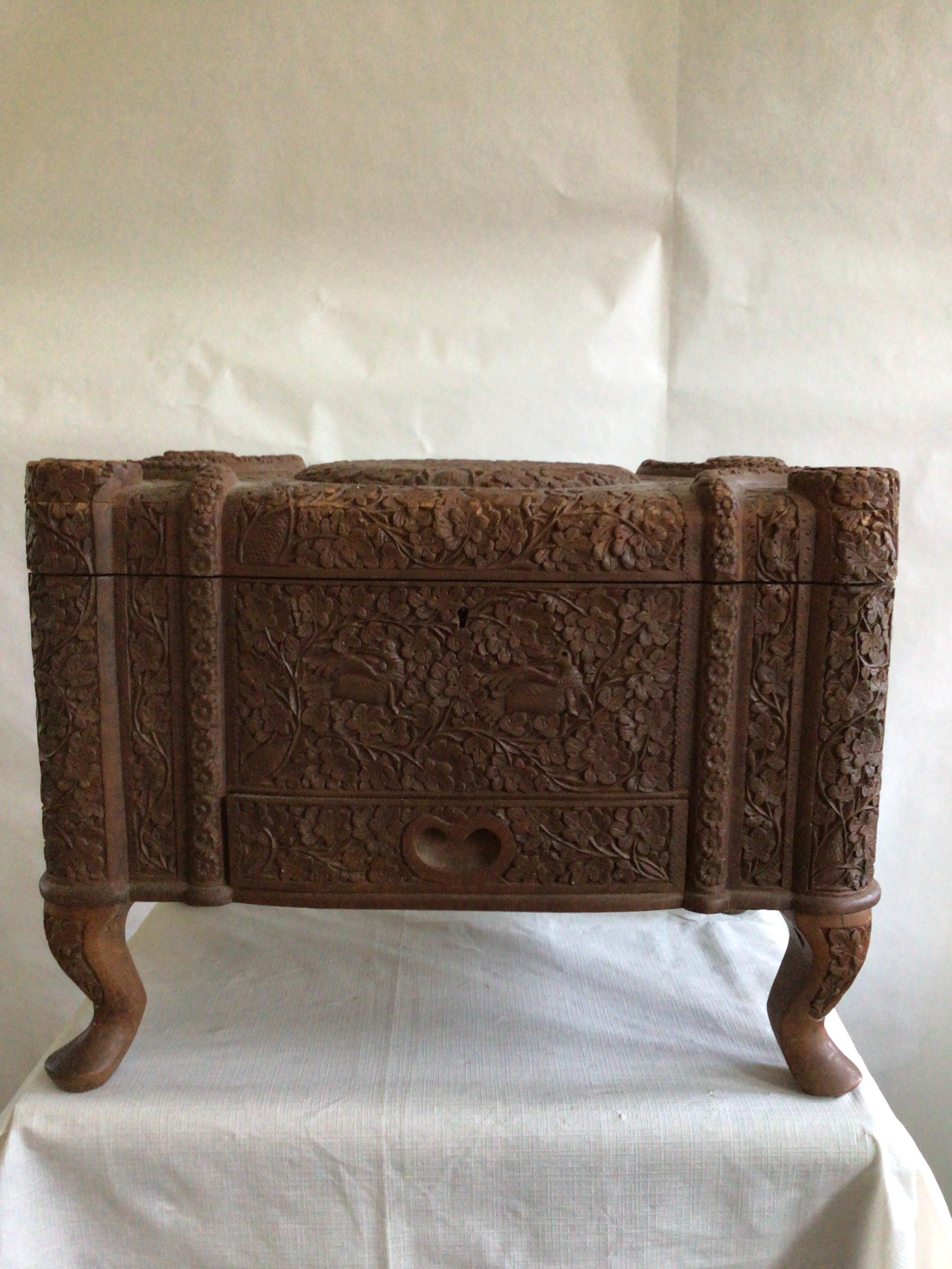 1950s Fine And Densely Carved Anglo-Indian Style Box
Drawer at outside base of box
South-Indian or Anglo-Indian style
Lacking keys
Decoration adorned on all sides depicting birds amongst floral vines 
The top opening to reveal a plain interior, with