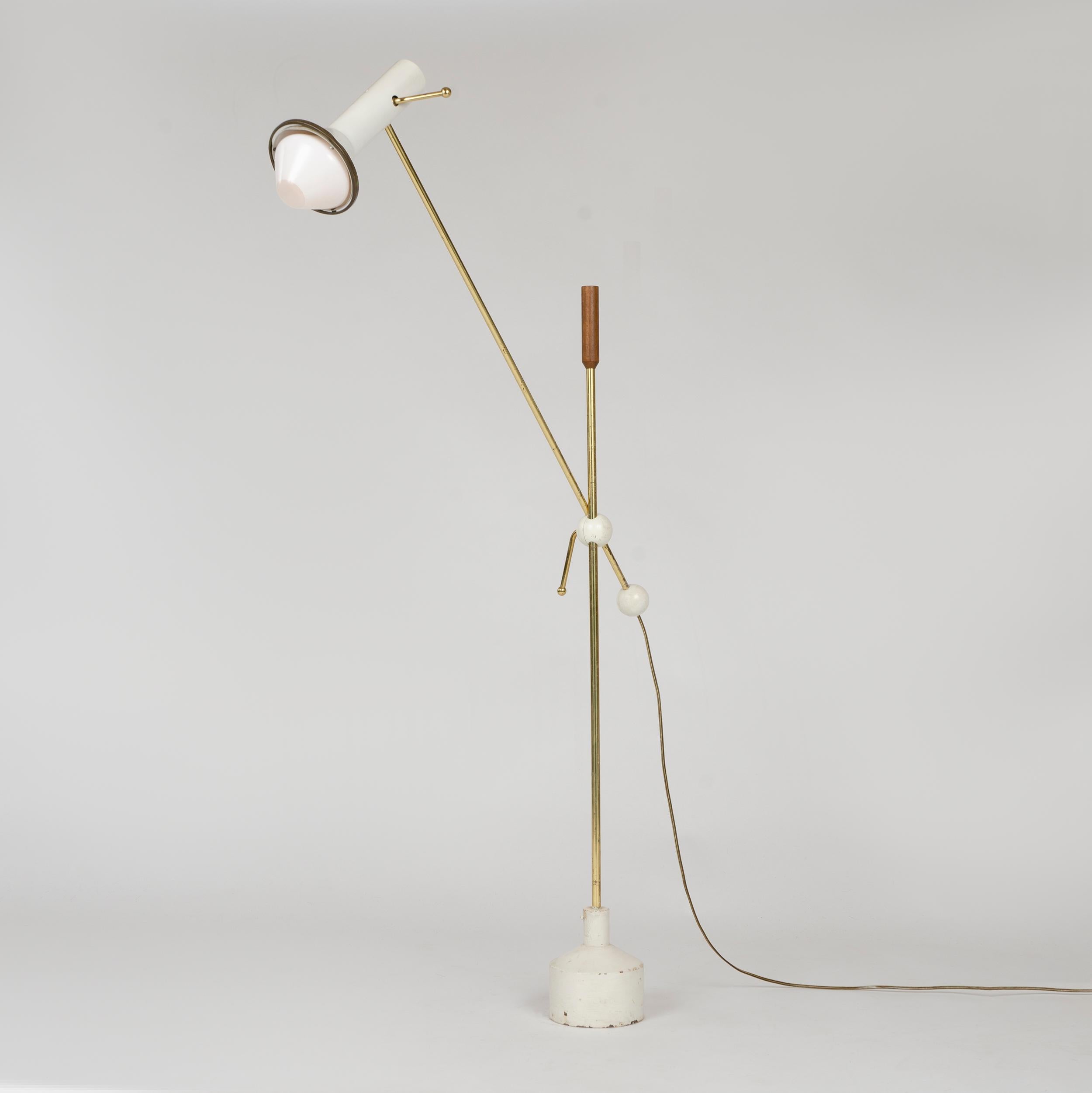 An uncommon Scandinavian brass and painted aluminum floor lamp with a cylindrical teak finial, cast-iron base, and an adjustable arm with a pivoting shade.
