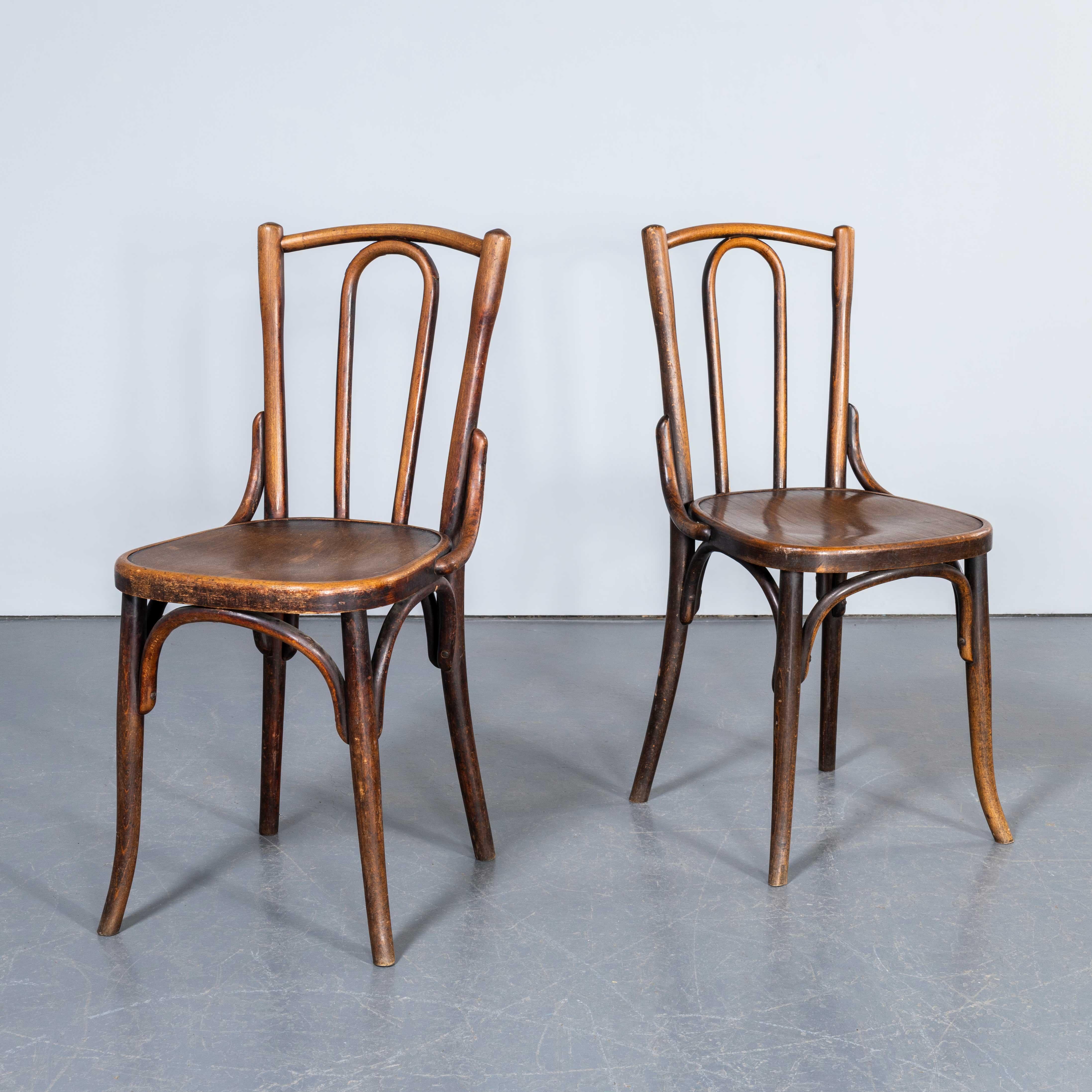 1950's Fischel Hooped Back Warm Oak Dining Chairs - Pair. 
The process of steam bending beech to create elegant chairs was discovered and developed by Thonet, but when its patents expired in 1869 many companies including Fischel launched production.