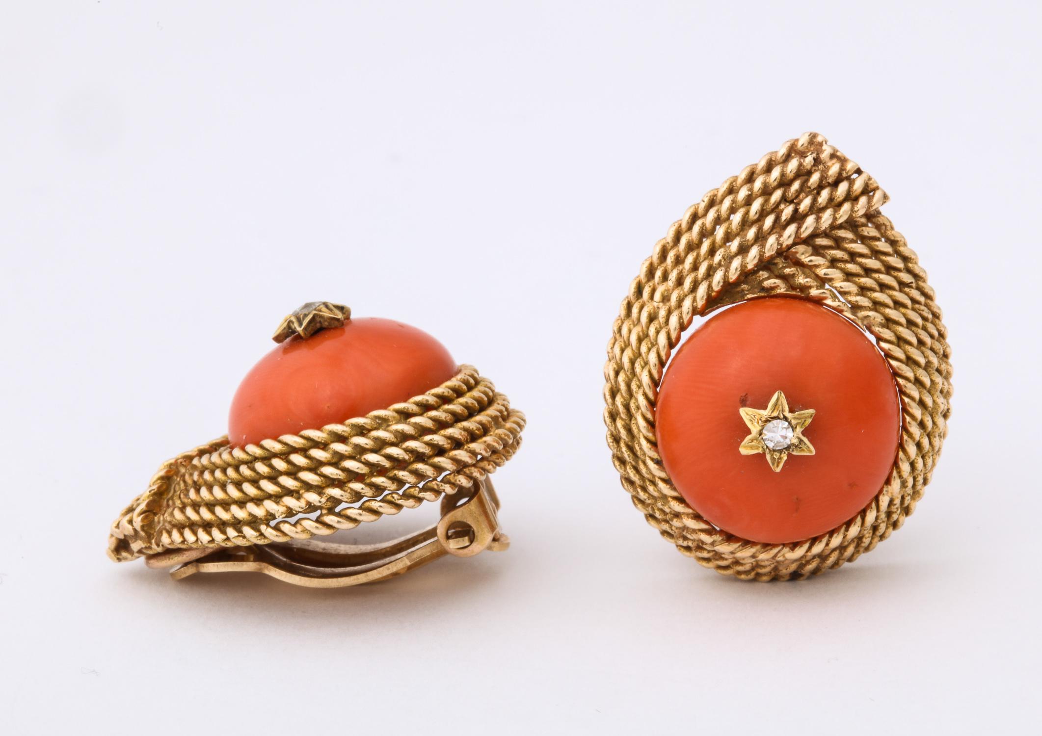 One Ladies 14kt Textured Gold Five Row Rope Design Earclips Centering A 20 MM Coral Cabochon Stone And In Center Of Coral Two Old Cut Diamonds Set In A Star Motif. Clip On Earrings Designed In The 1950's In The United States Of America. NOTE:Posts