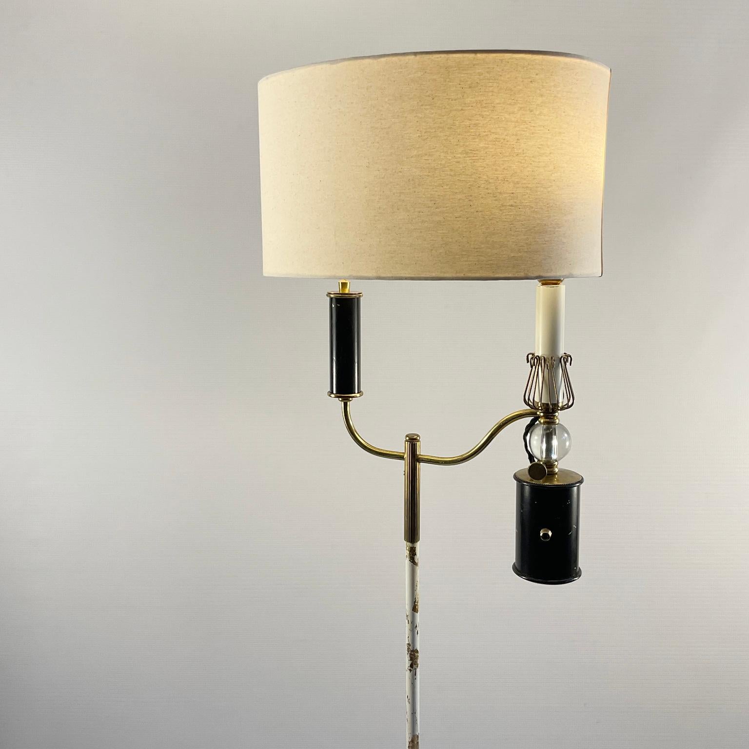The design of this 1950s floor lamp manufactured by Maison Lunel is inspired by the Argand oil lamp invented in the 18th century by Aimé Argand and later popularized in France by a pharmacist named Antoine Quinquet who made modifications for more