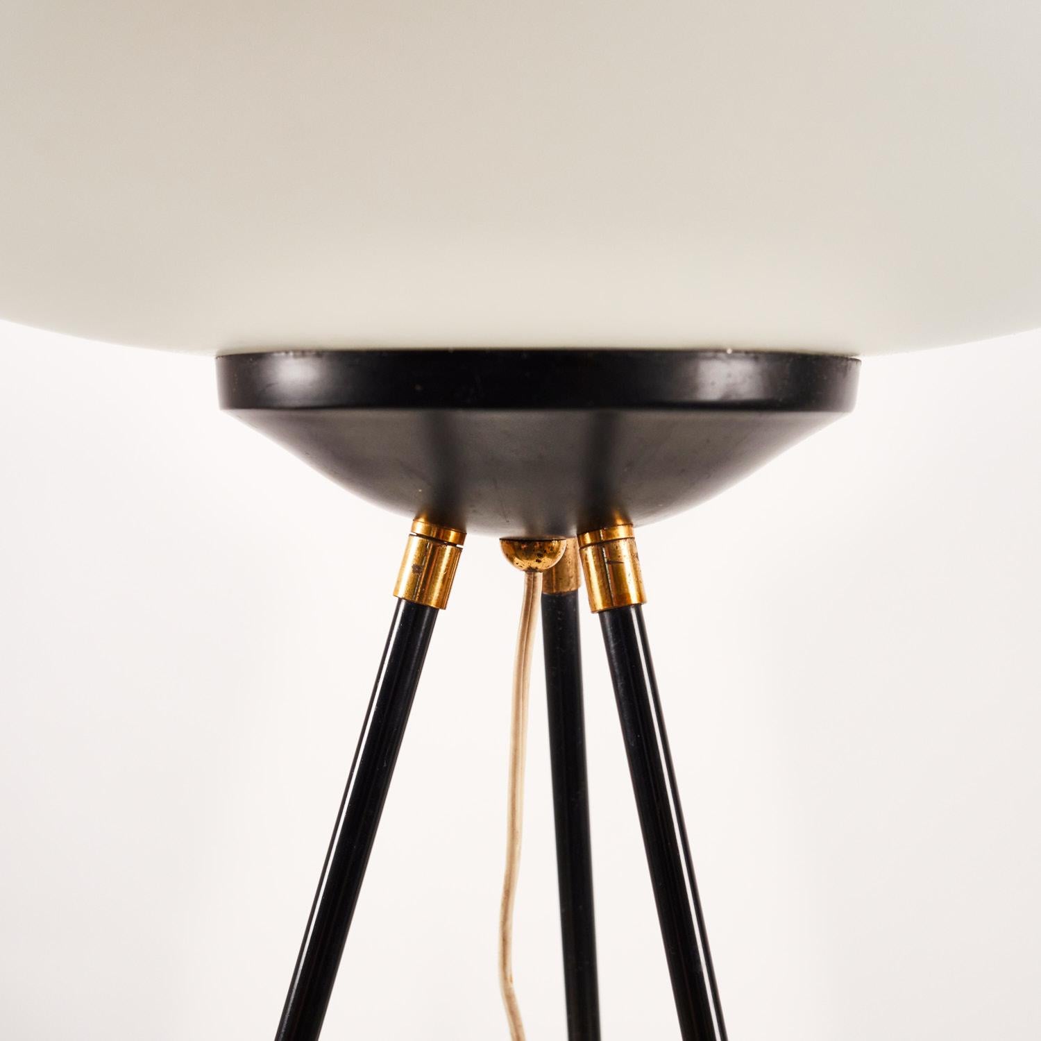 Three legged floor lamp manufactured by Chiarini in Milan in the late 1950's. Brass and lacquered brass frame, lacquered aluminium and white opaline glass shade.