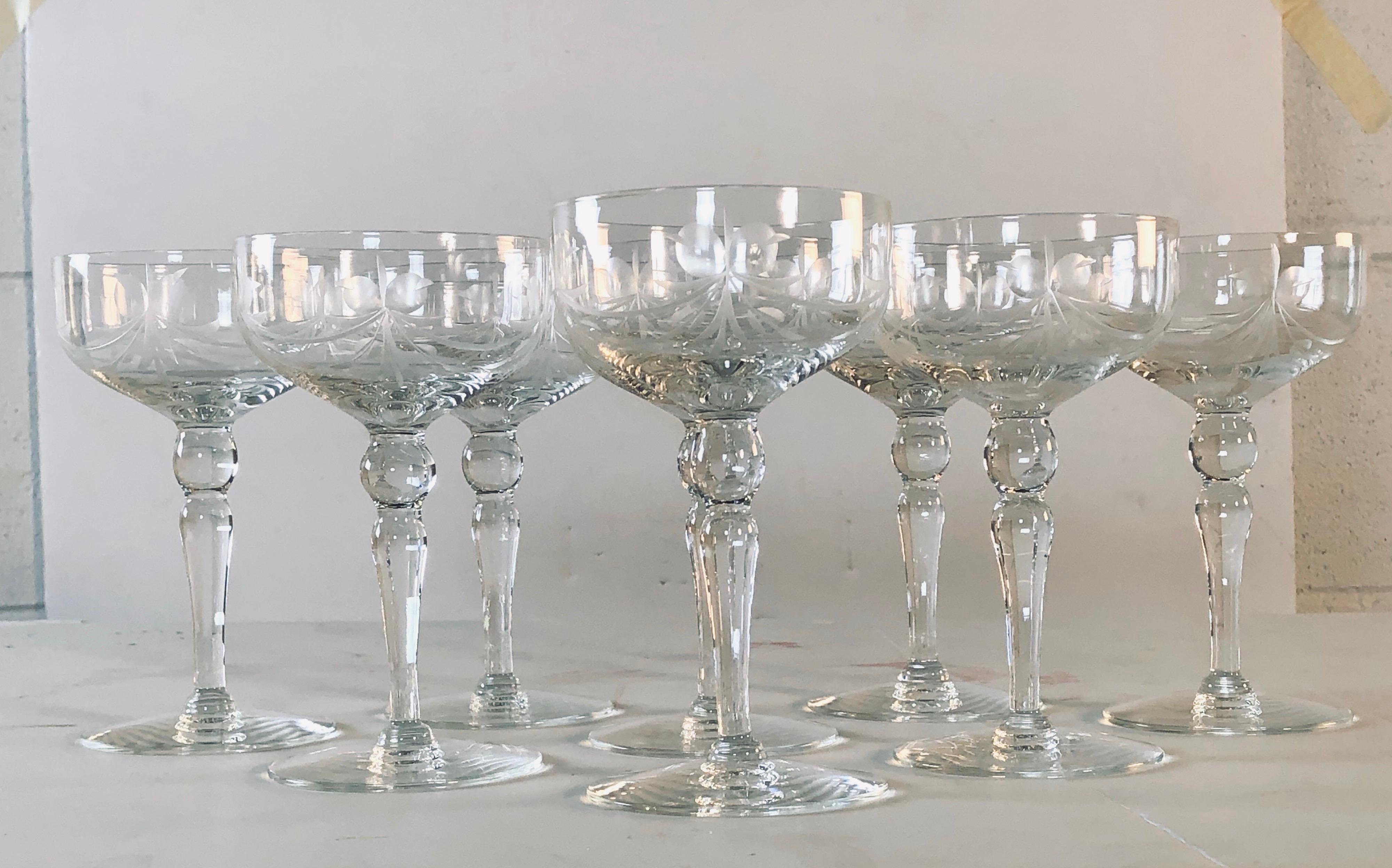 Vintage 1950s set of 8 glass coupes with an etched floral and bow tie design. No marks. Excellent condition.